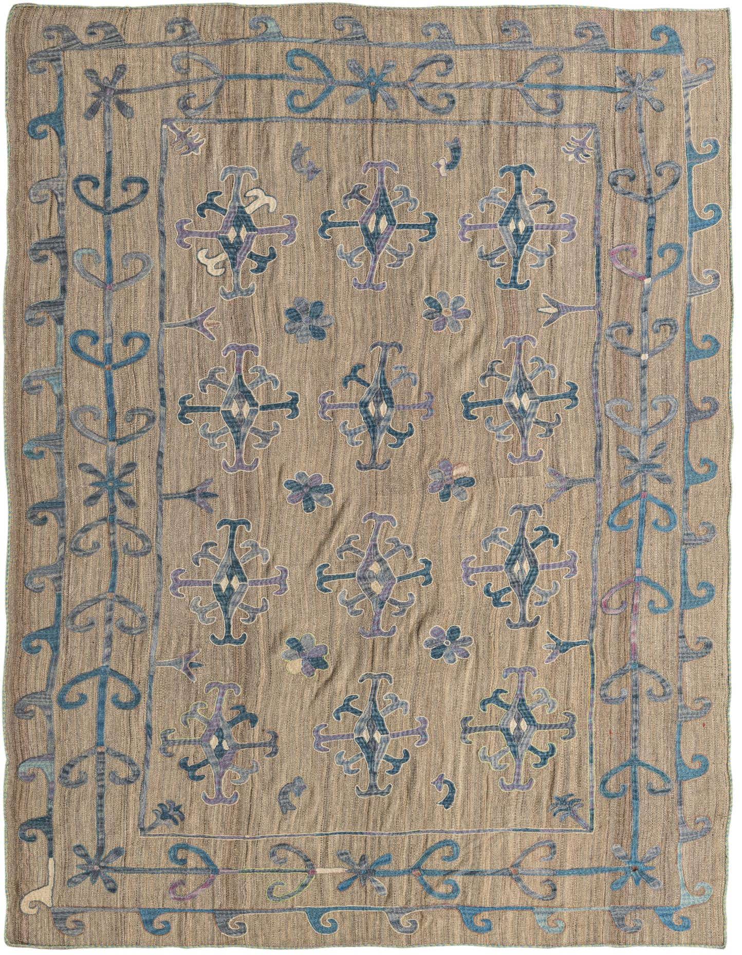 A 6x9 rectangular Kilim Suzani rug featuring a tan background with blue and purple tribal patterns and a decorative border.