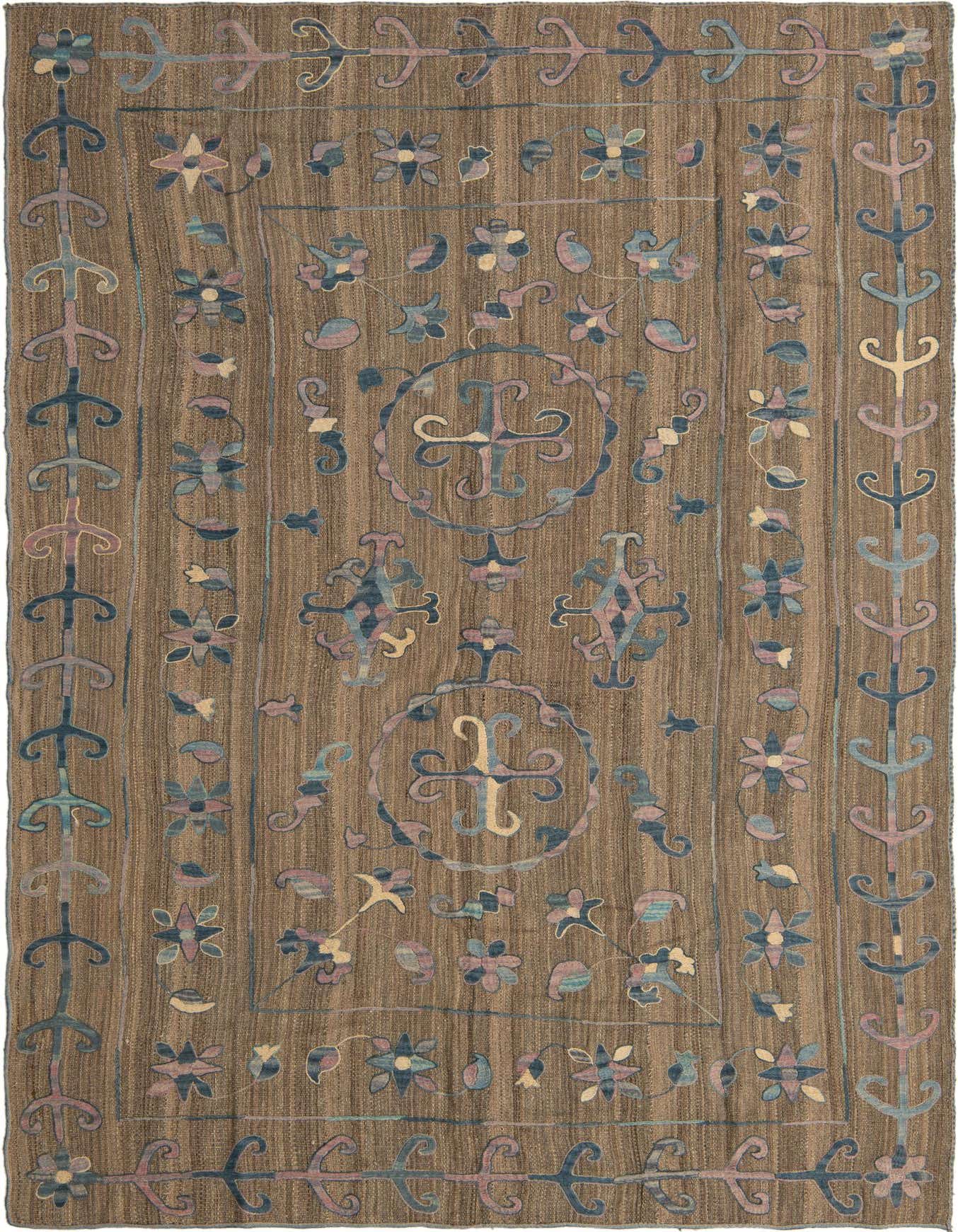 A 6x9 rectangular brown Kilim Suzani rug with tribal floral and abstract patterns in blue, pink, and tan.
