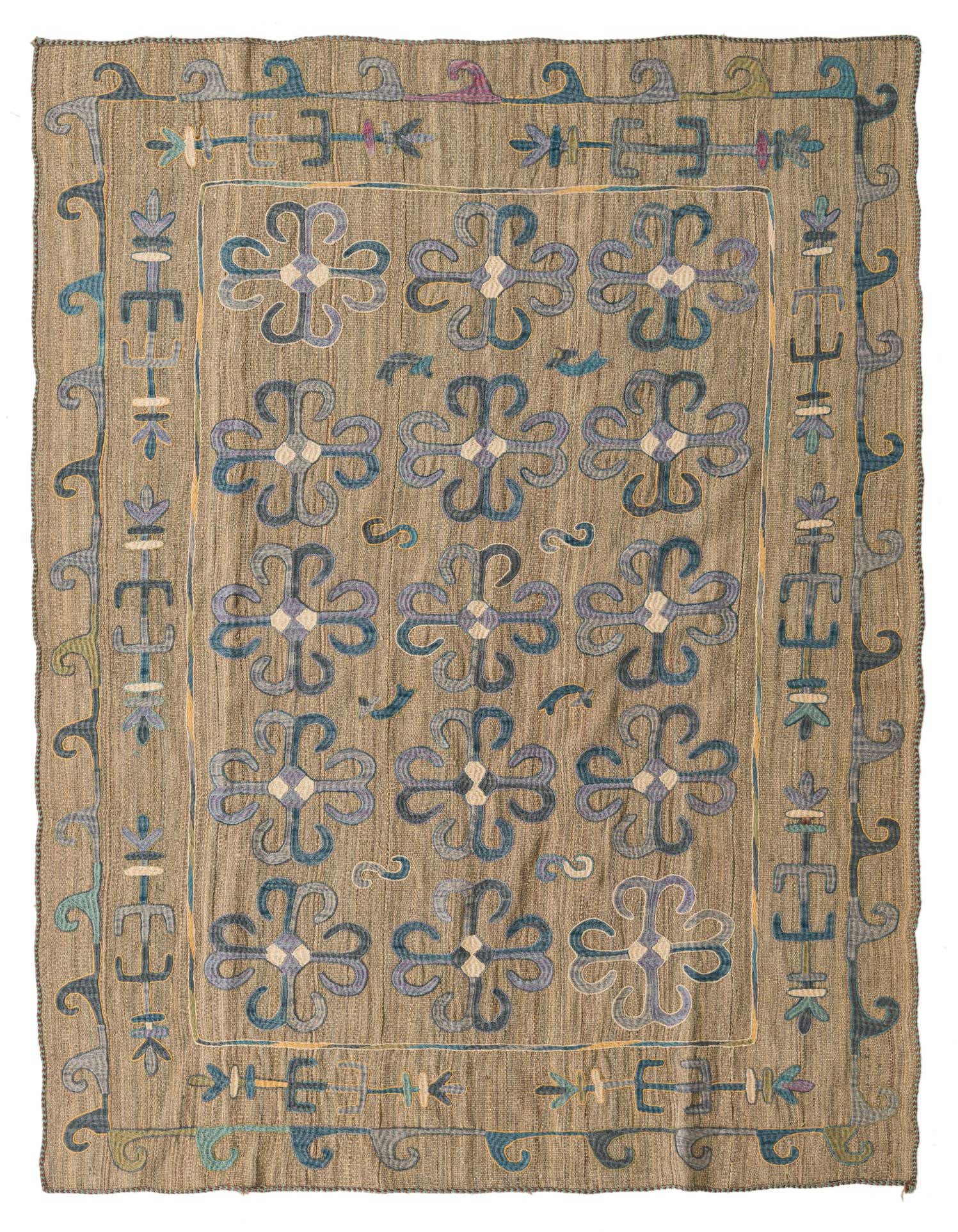 A 5x8 rectangular Kilim Suzani rug in browns and tans with a tribal pattern of blue and purple floral motifs.