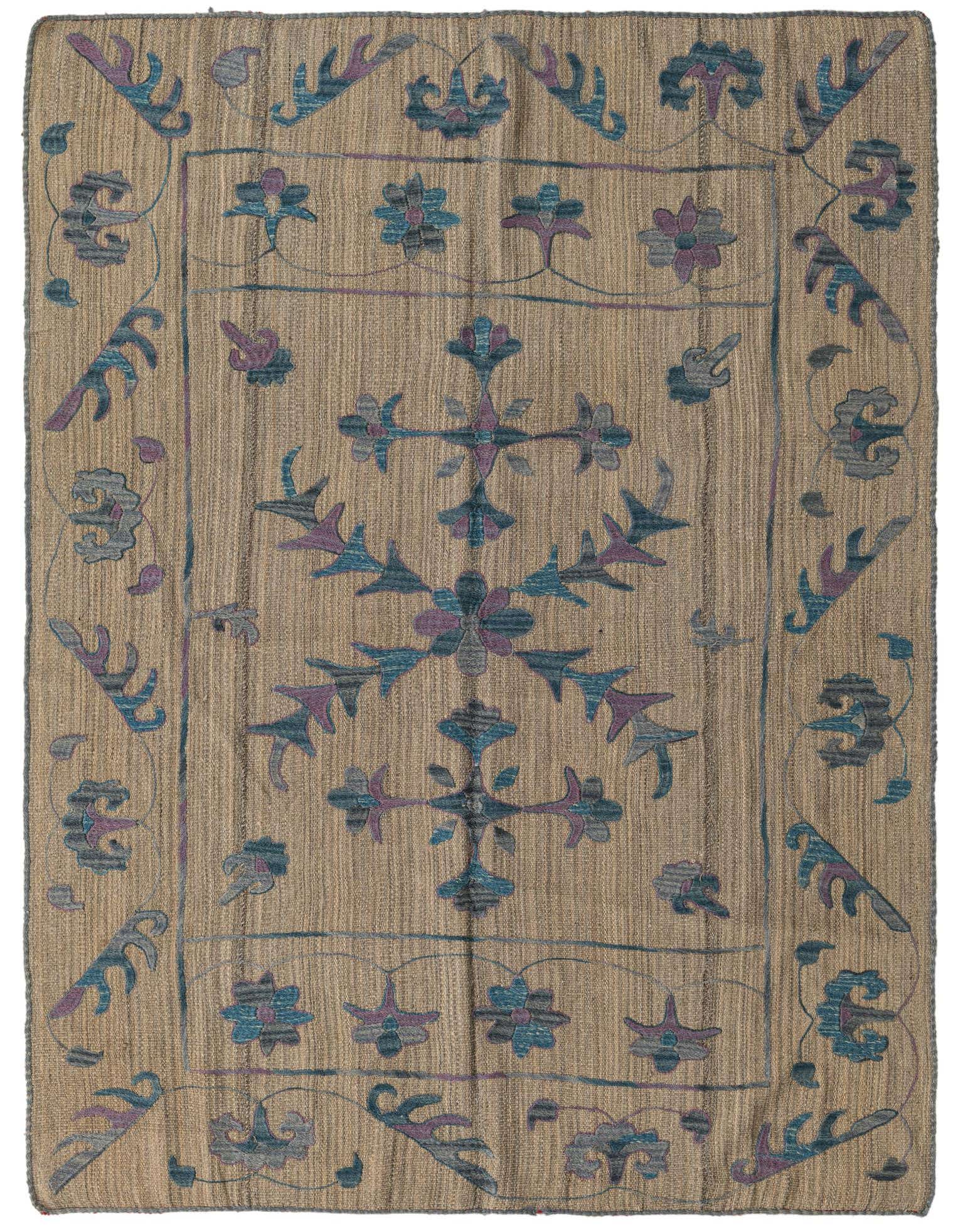 A 4x6 rectangular Kilim Suzani rug with a flatweave texture. It features a tan-brown background with a central floral medallion and border in teal, blue, and purple tribal patterns.