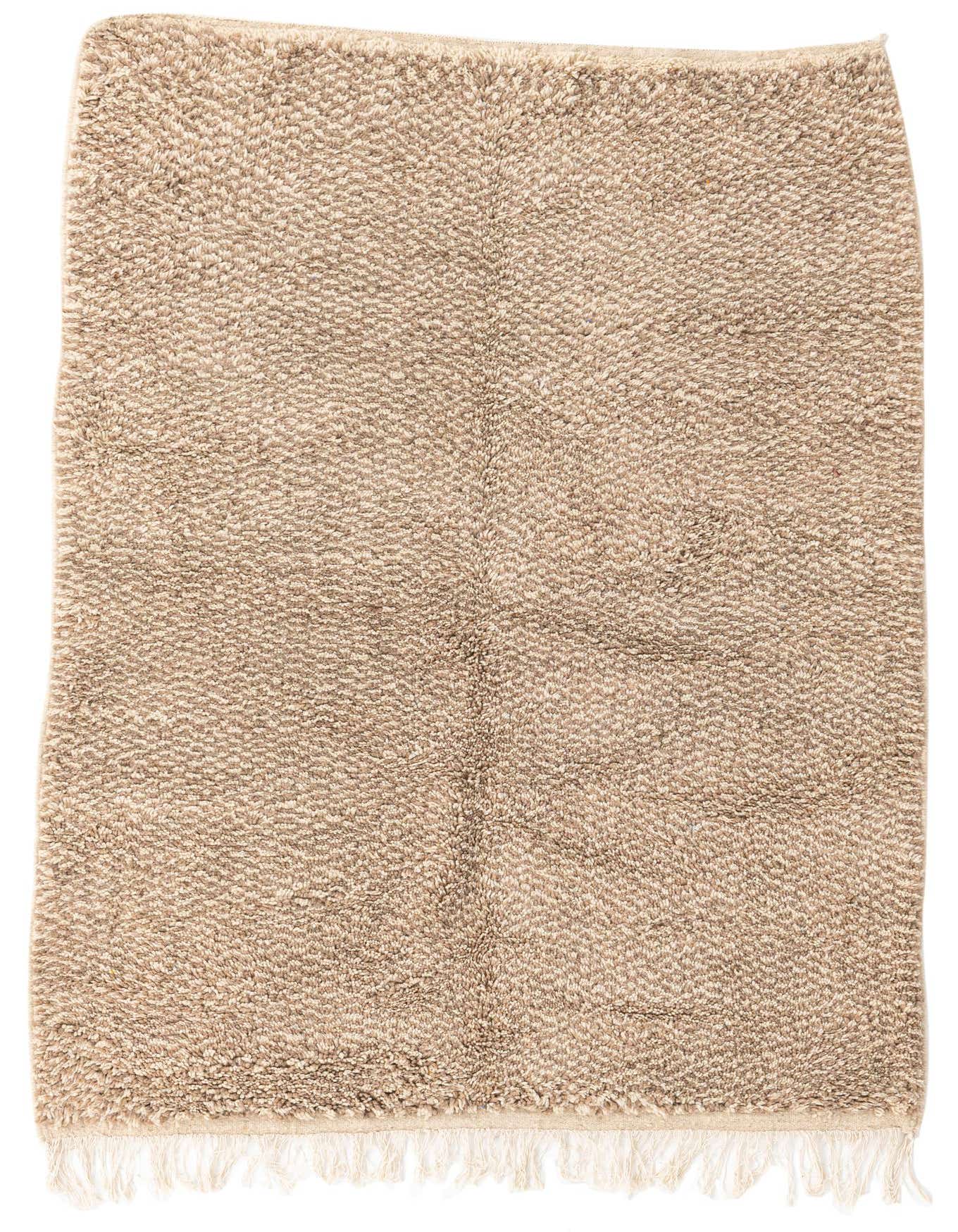 A 5x7 rectangular Moroccan shag rug in varying shades of brown and tan, featuring a subtle tribal pattern and fringe.