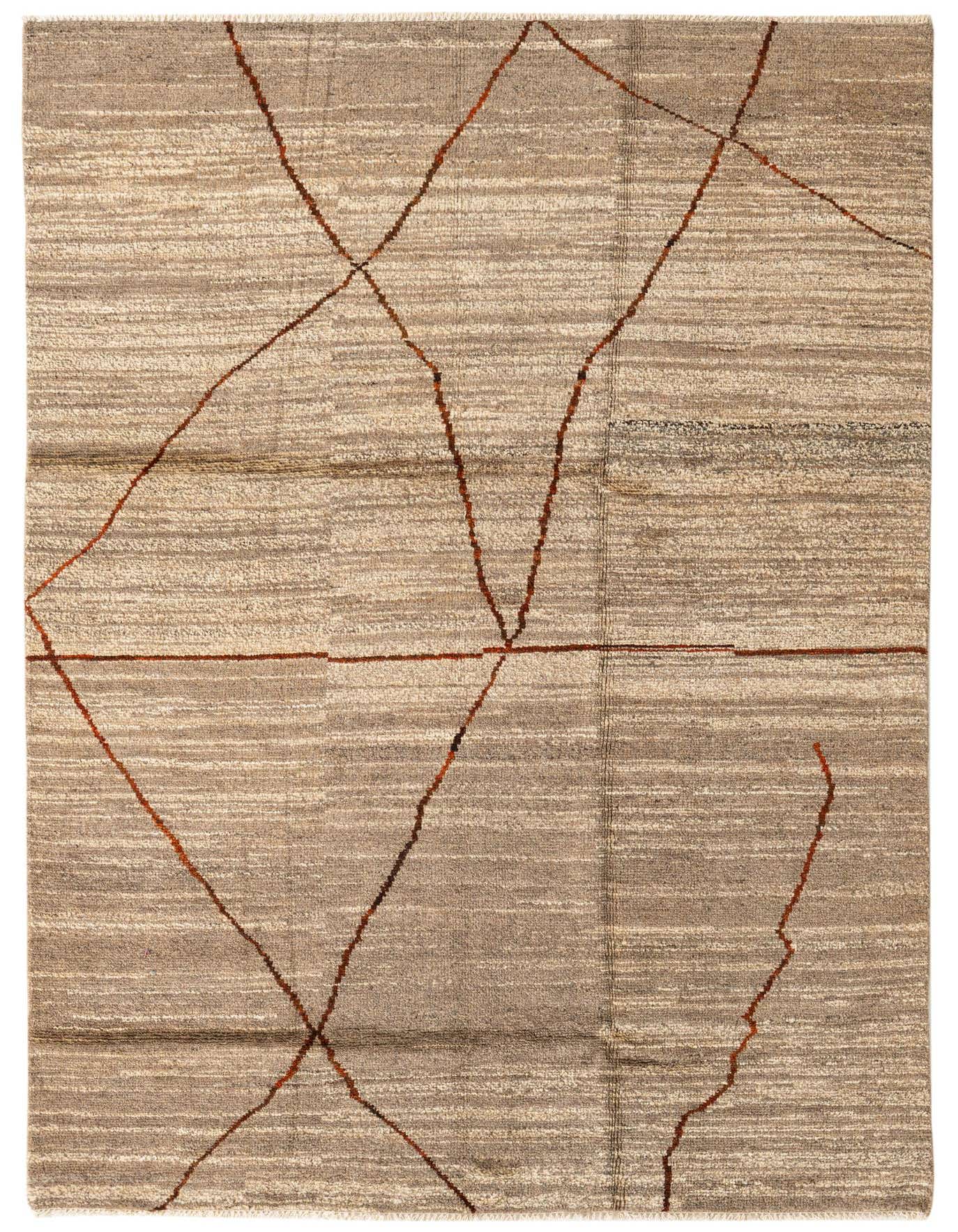 A 5x8 rectangular brown and tan wool shag rug with an abstract tribal pattern, suitable for a living room.