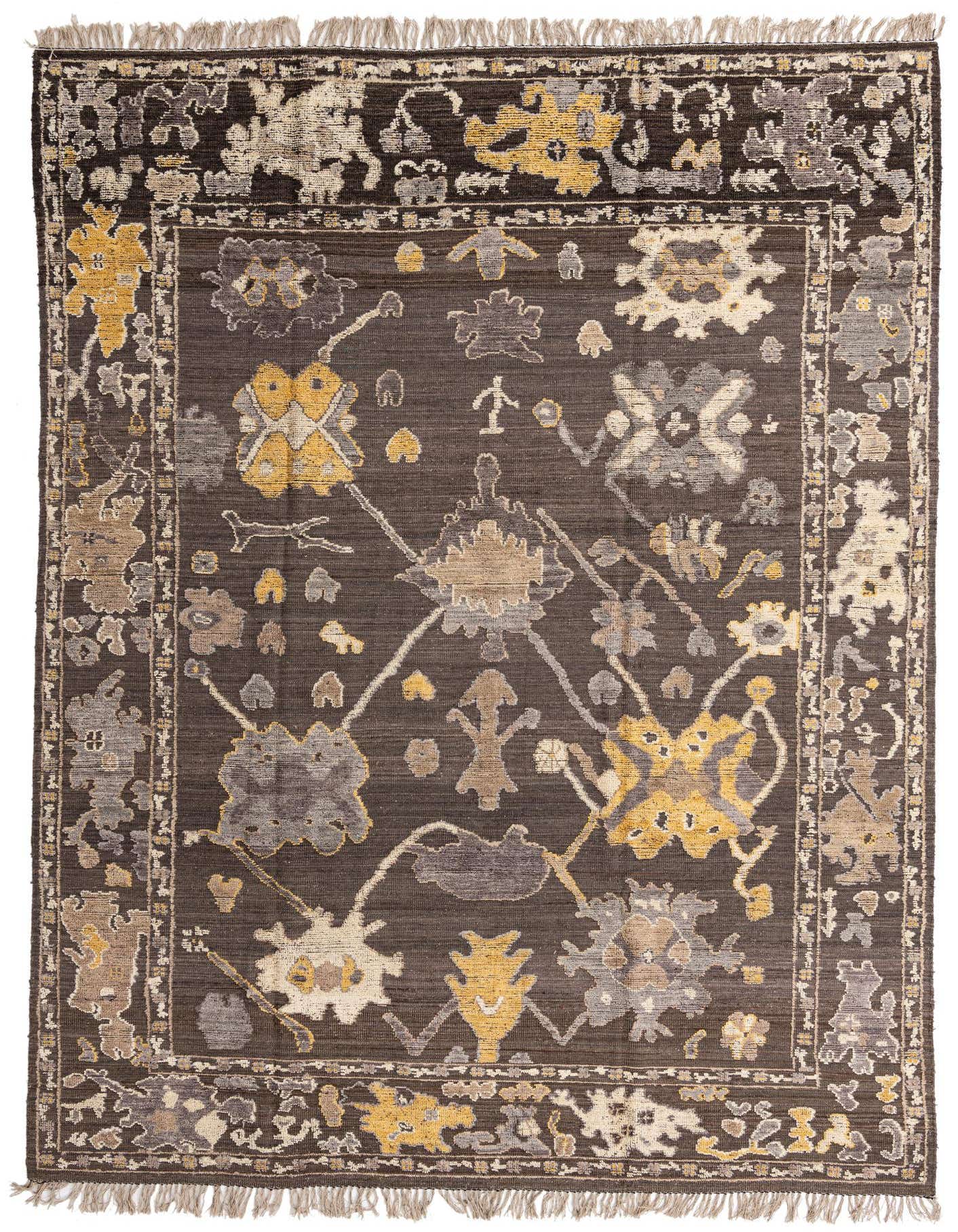 A 10x14 rectangular Oushak wool rug with a dark brown field and abstract floral patterns in tan, cream, and mustard yellow, featuring a decorative border and fringed ends.