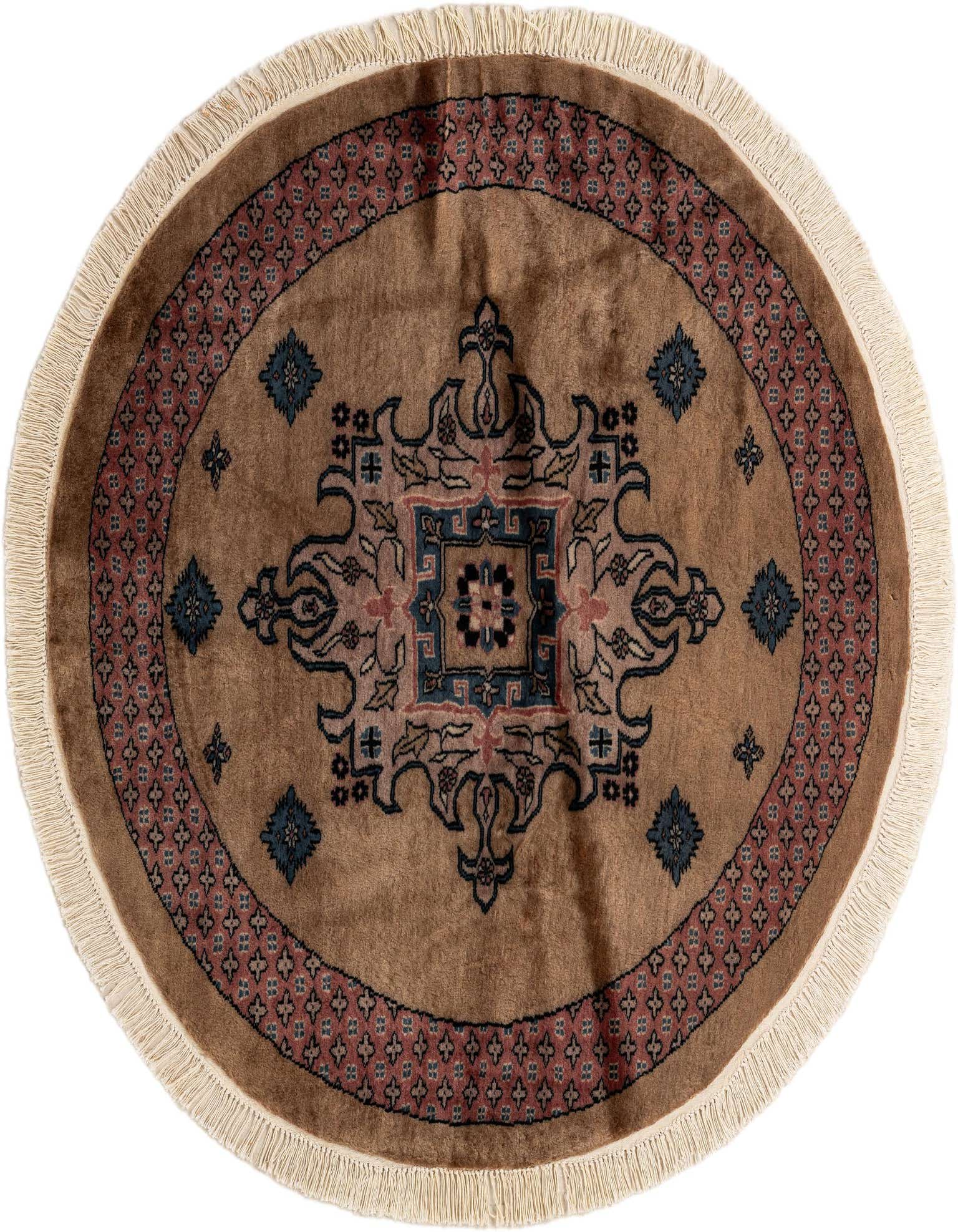 A 4' round brown wool rug with a central medallion and tribal patterns in blue, black, and pink, featuring a fringed edge.