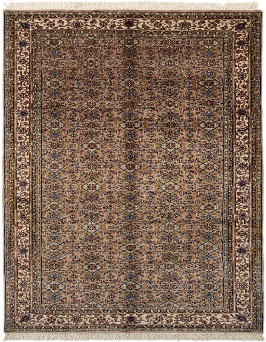 A traditional 11 ft runner rug in browns and tans with an intricate floral pattern and fringed ends.