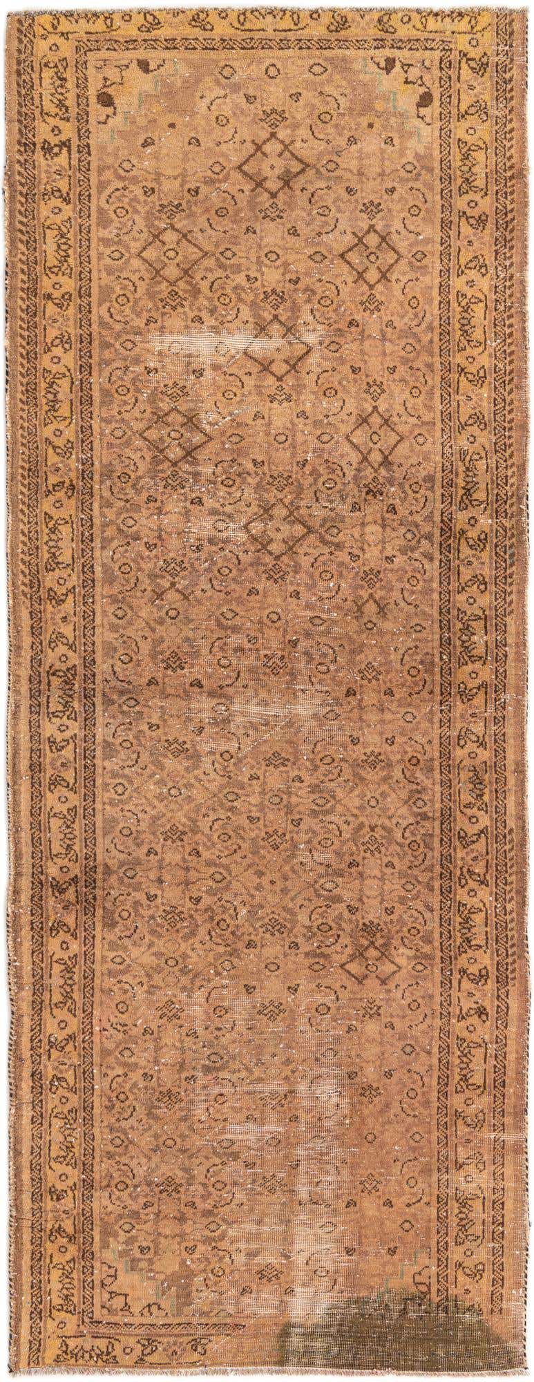 A 10 ft runner rug in shades of brown and tan, featuring a distressed Persian traditional pattern with a decorative border, suitable for a hallway.