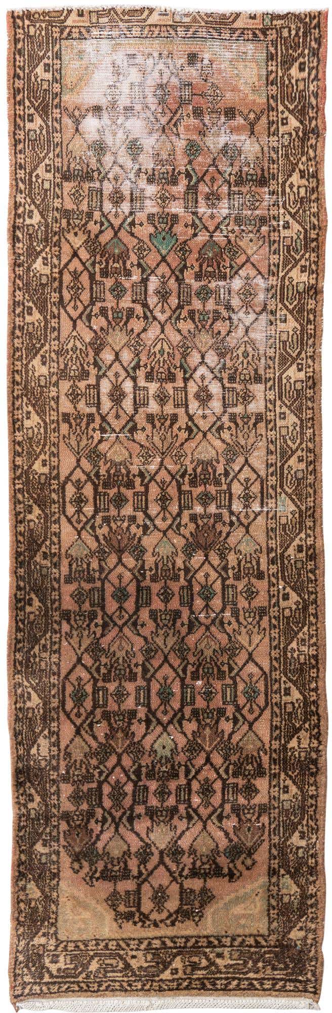 A 9 ft Ultra Vintage runner rug in browns and tans with a distressed Persian pattern, ideal for a hallway.