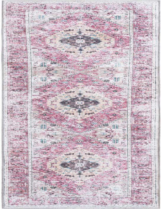 A 10 ft runner rug in a distressed bohemian tribal pattern with oranges, pinks, and hints of blue and cream.