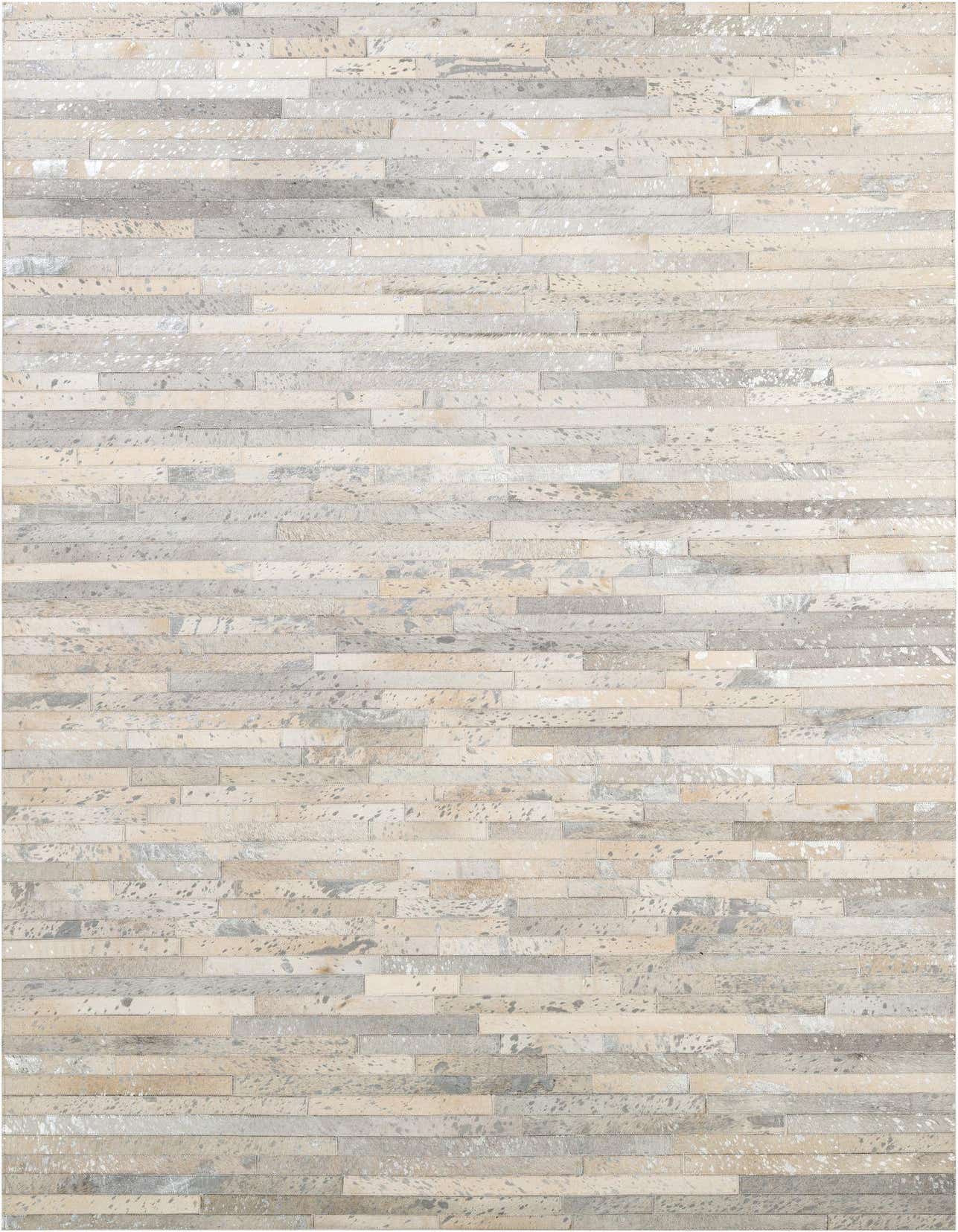 A 5x8 rectangular Cowhide Patchwork rug featuring varying shades of gray and silver stripes, perfect for a modern living room.