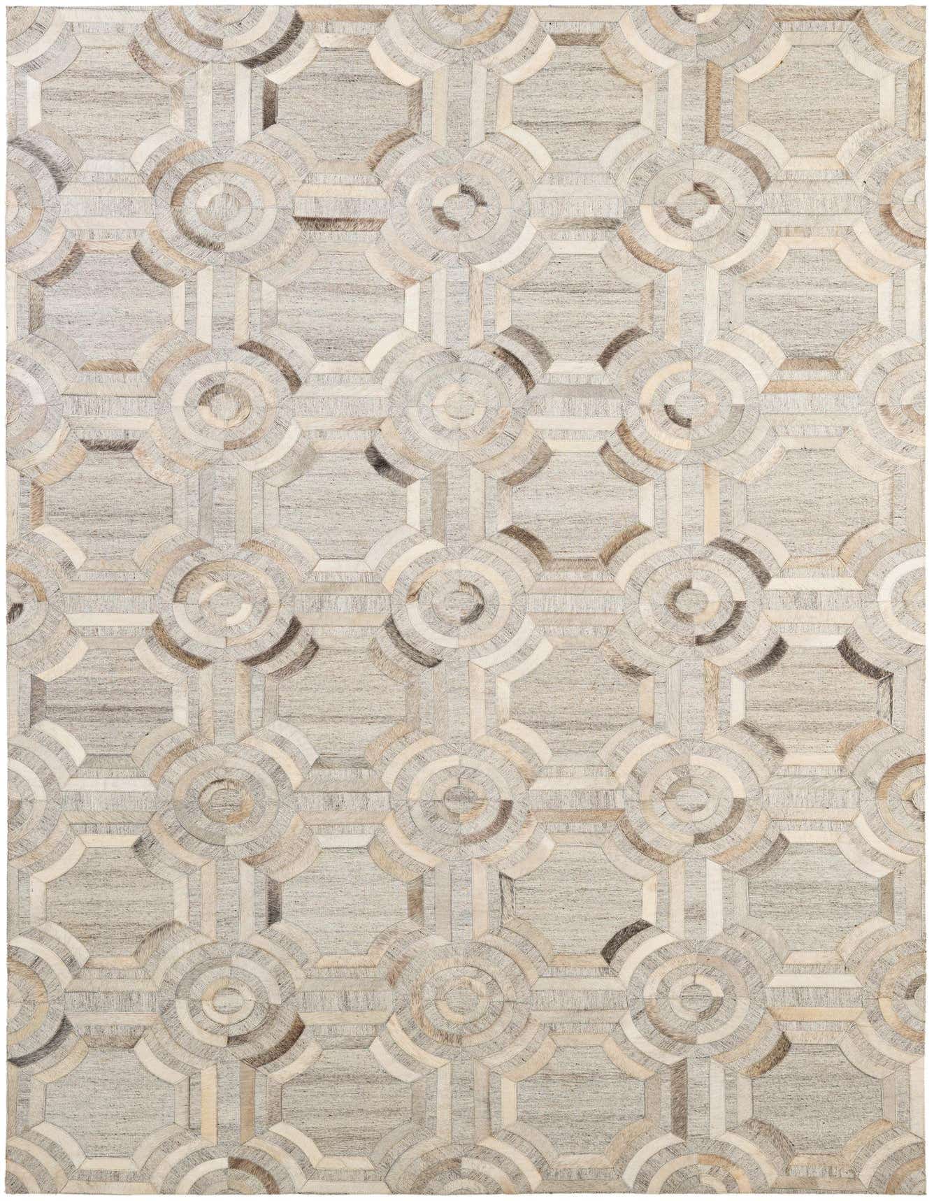 A 5x8 rectangular gray modern rug with a geometric patchwork pattern of cowhide and leather, ideal for a living room.