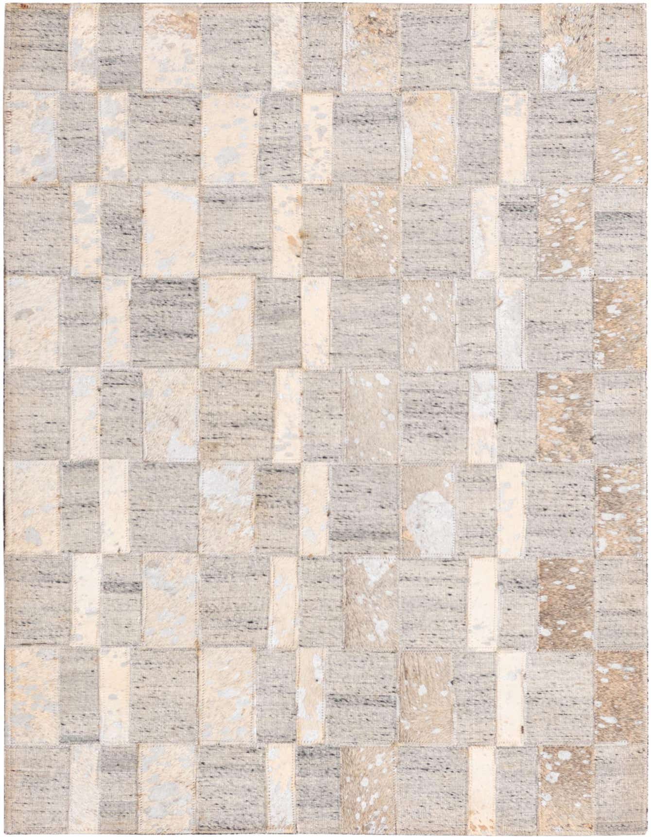 A 2x3 rectangular modern rug featuring a patchwork of gray woven fabric and light gray and beige cowhide with natural speckles.