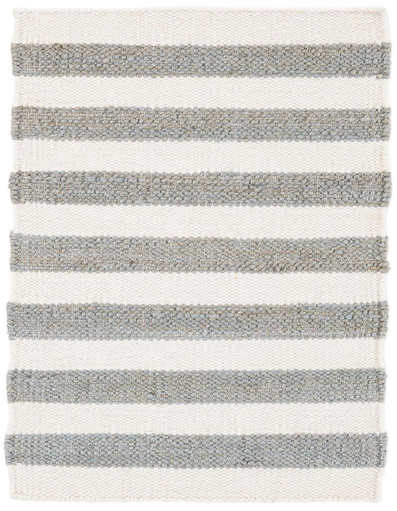 A 2x3 rectangular Jill Zarin Hamptons rug with thick gray and white horizontal stripes, handmade from jute and wool.