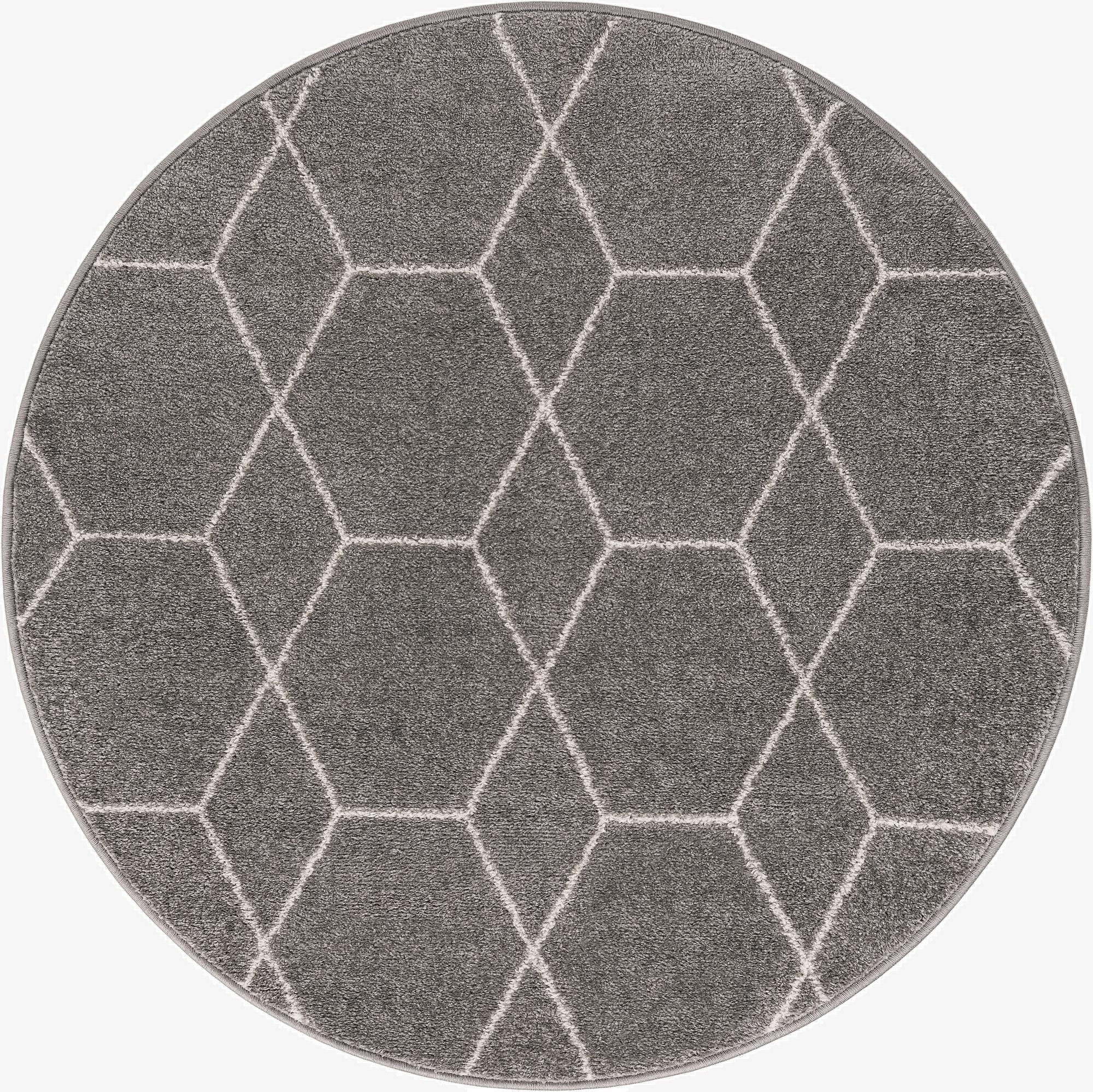 A 4' round gray area rug with a modern white geometric trellis pattern, suitable for various indoor spaces.