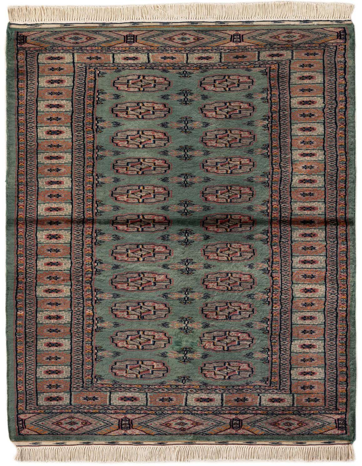 A 3x5 rectangular green Bokhara tribal rug with a shag pile, featuring intricate geometric patterns in muted reds, blues, and creams, and white fringed ends.