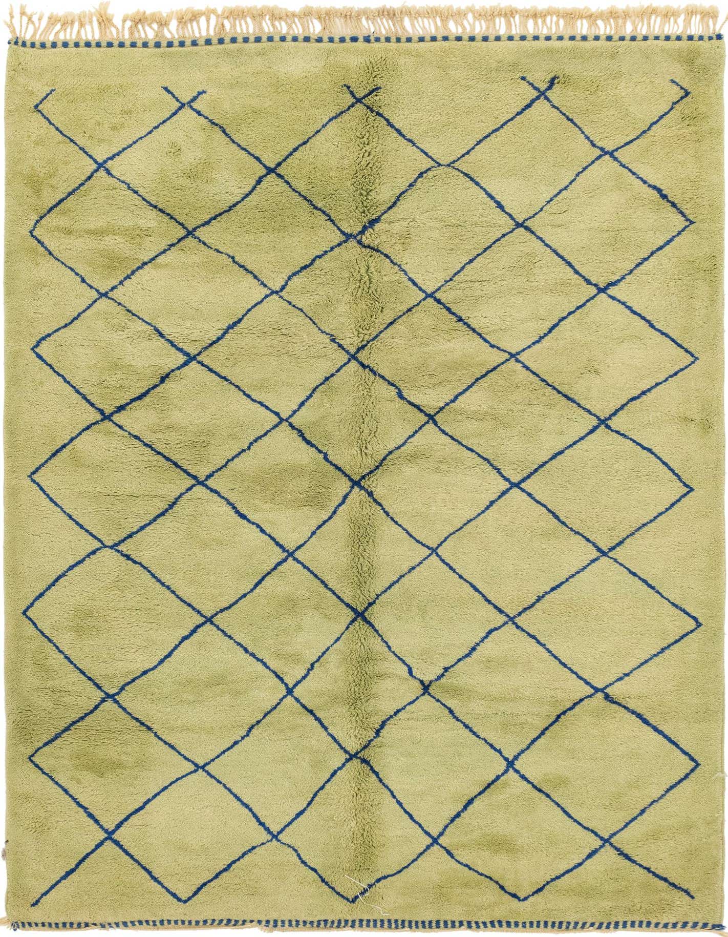 A 7x10 rectangular green shag rug with a bold blue tribal diamond pattern and fringed edges, suitable for a living room.