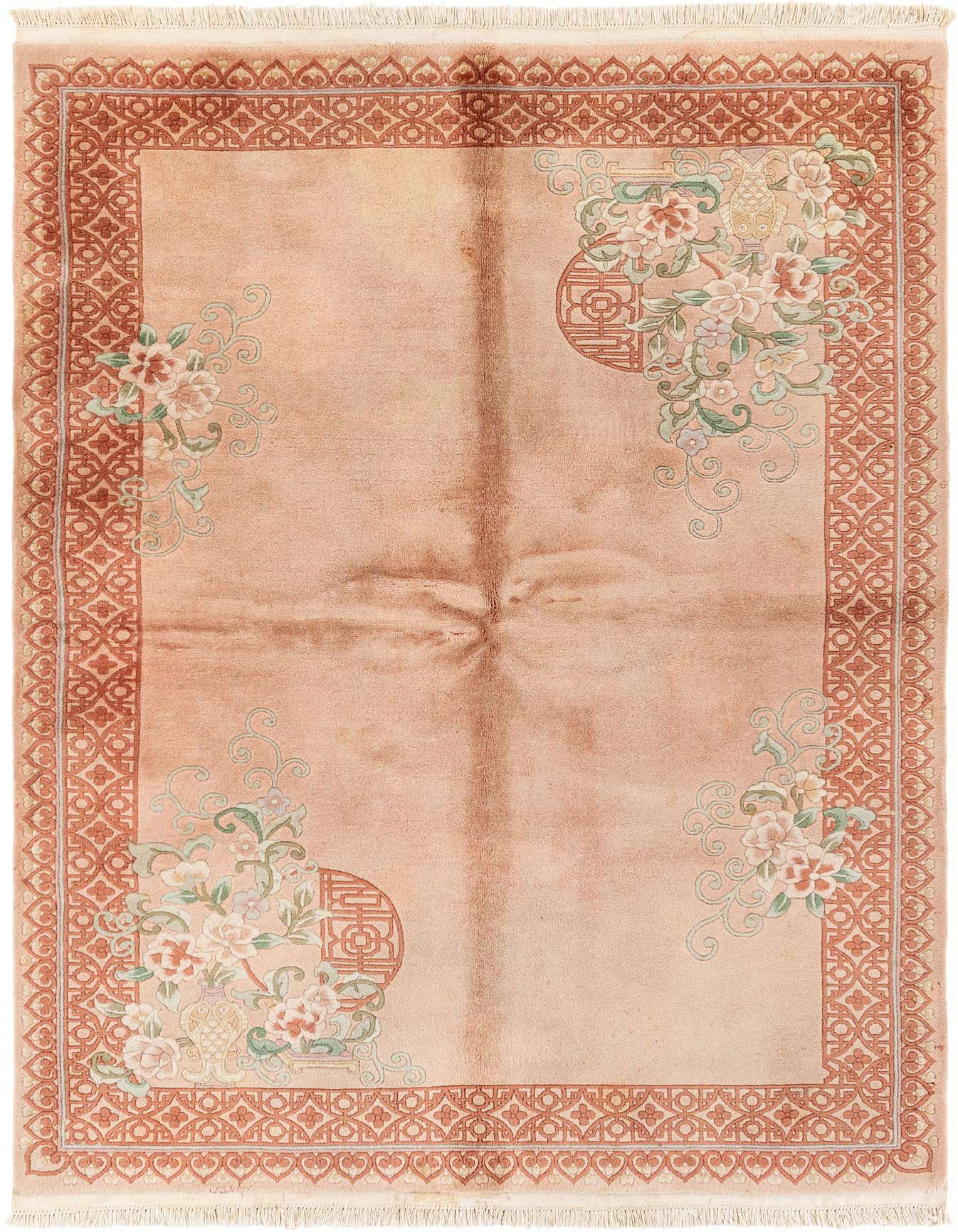 A 5x8 rectangular pink wool rug with a traditional medallion pattern and floral accents, ideal for a living room.