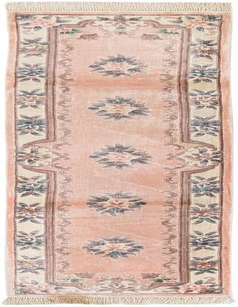 A 10 ft pink wool runner rug with an oriental floral medallion pattern and fringed ends, ideal for a hallway.