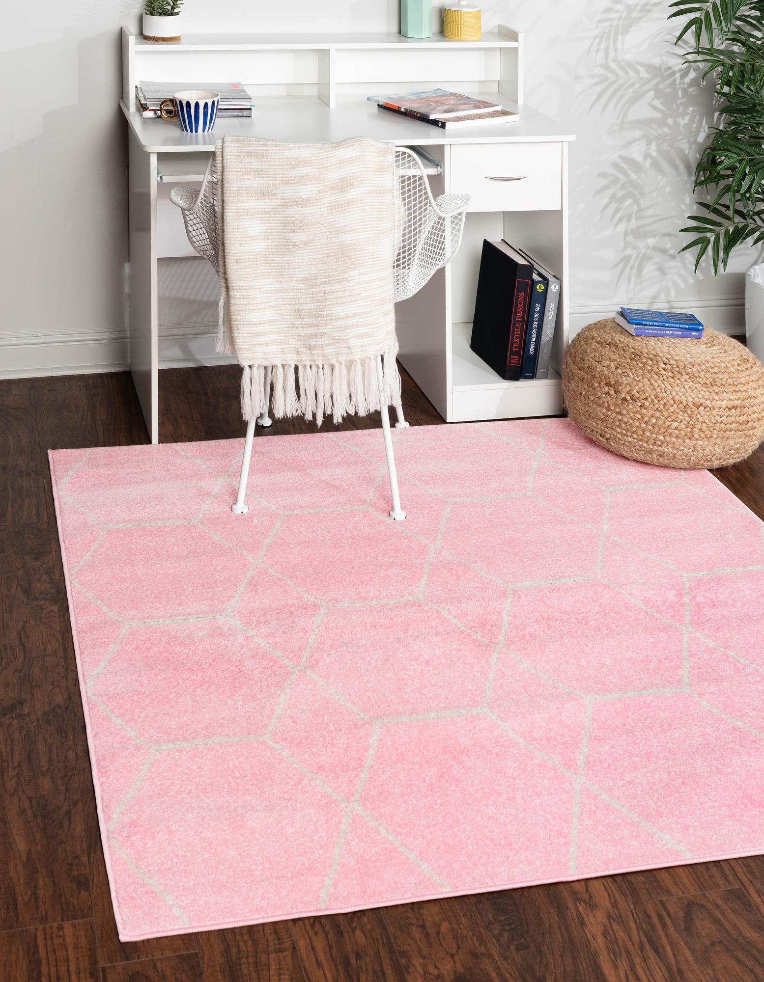 A 7x7 square pink rug with a modern white geometric trellis pattern, suitable for an indoor living space.
