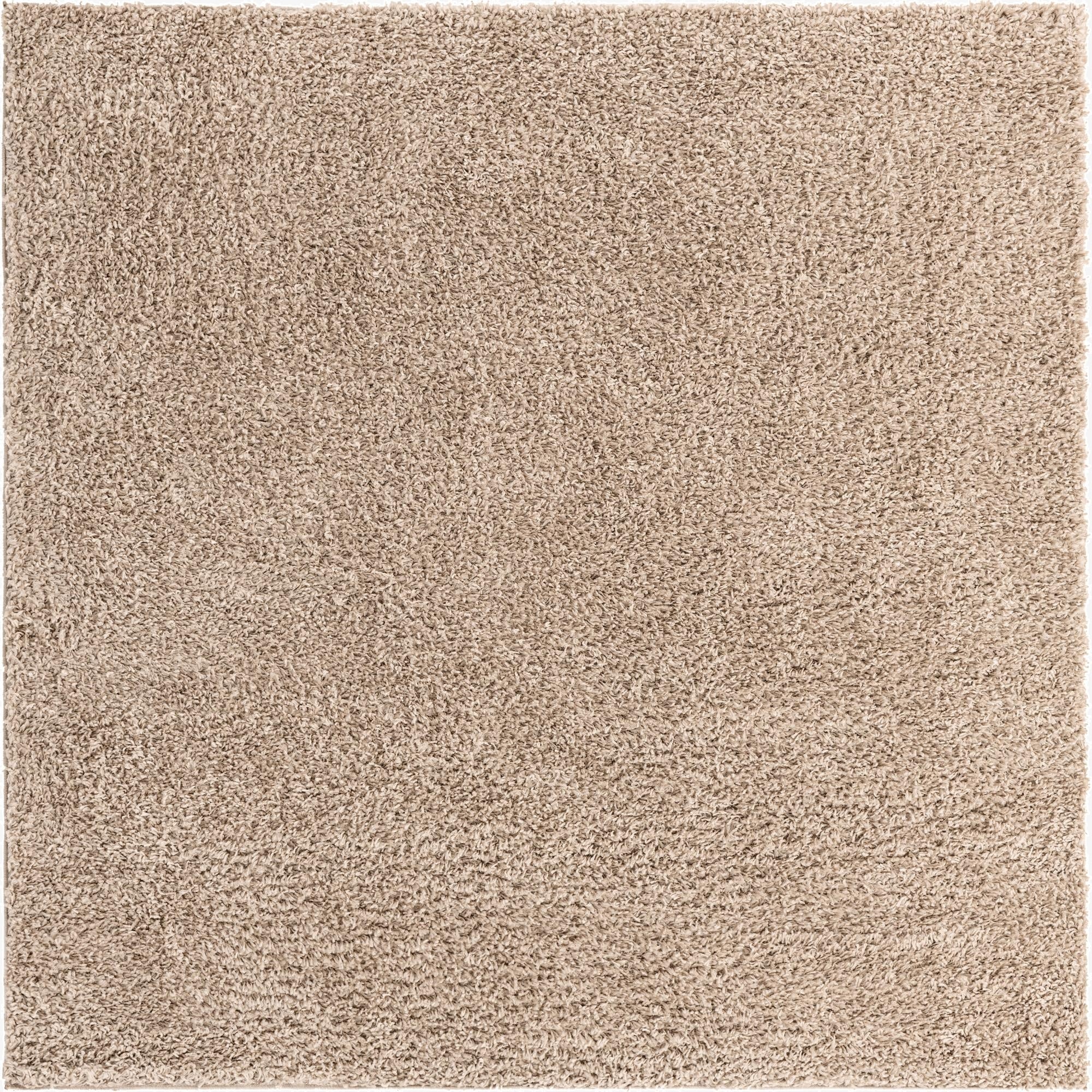 A soft, plush Zermatt Shag square rug in a solid ivory and cream color, perfect for adding comfort to any indoor space.