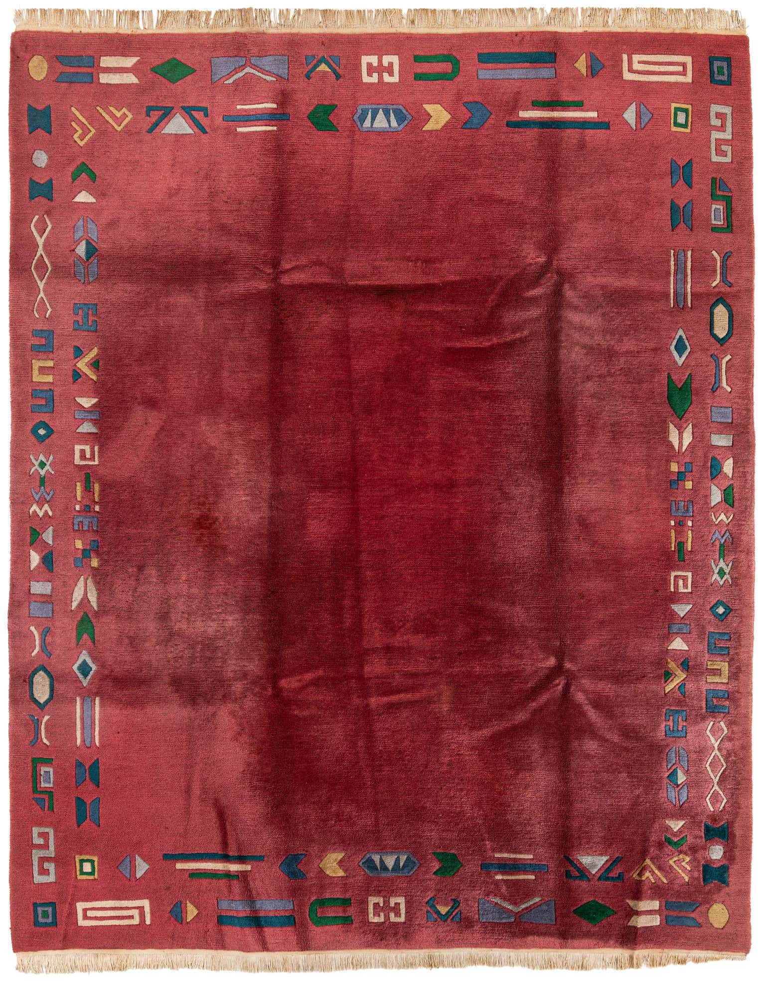 A 7x10 rectangular pink wool rug with a colorful abstract border of geometric shapes, suitable for a living room.