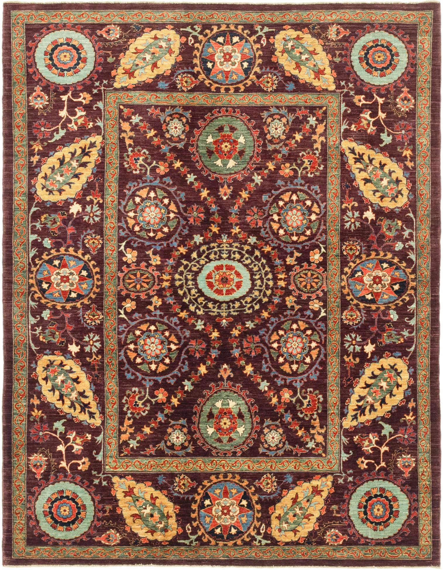 A 6x9 rectangular Ariana Ziegler rug featuring a rich red background with intricate traditional tribal patterns in blue, gold, and green.
