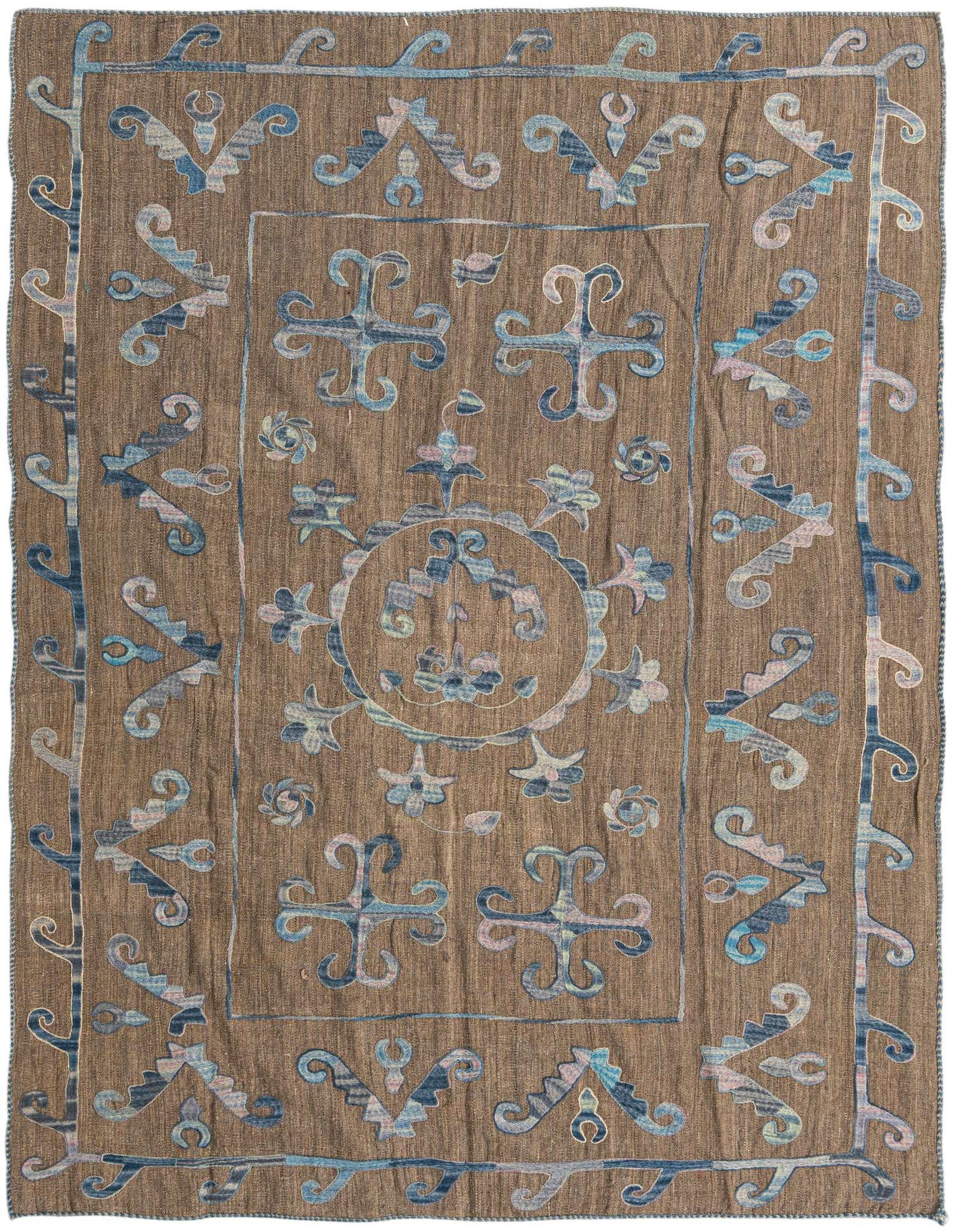 A rectangular 5x8 Kilim Suzani rug featuring a tribal floral pattern in shades of red and blue on a flatweave wool base.