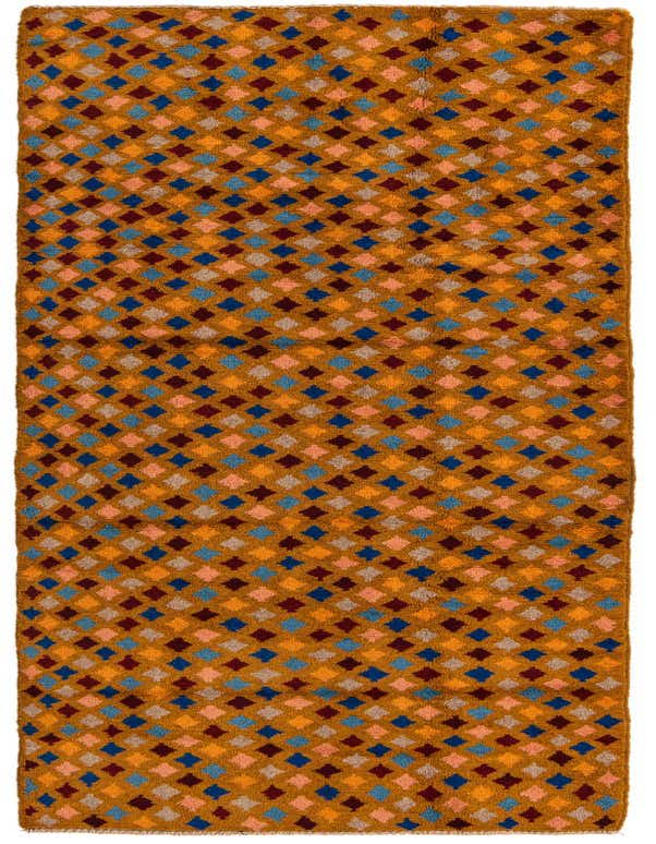 A 10 ft runner rug in a tribal, modern, abstract pattern with red, blue, orange, and light pink diamond shapes on a mustard yellow background.