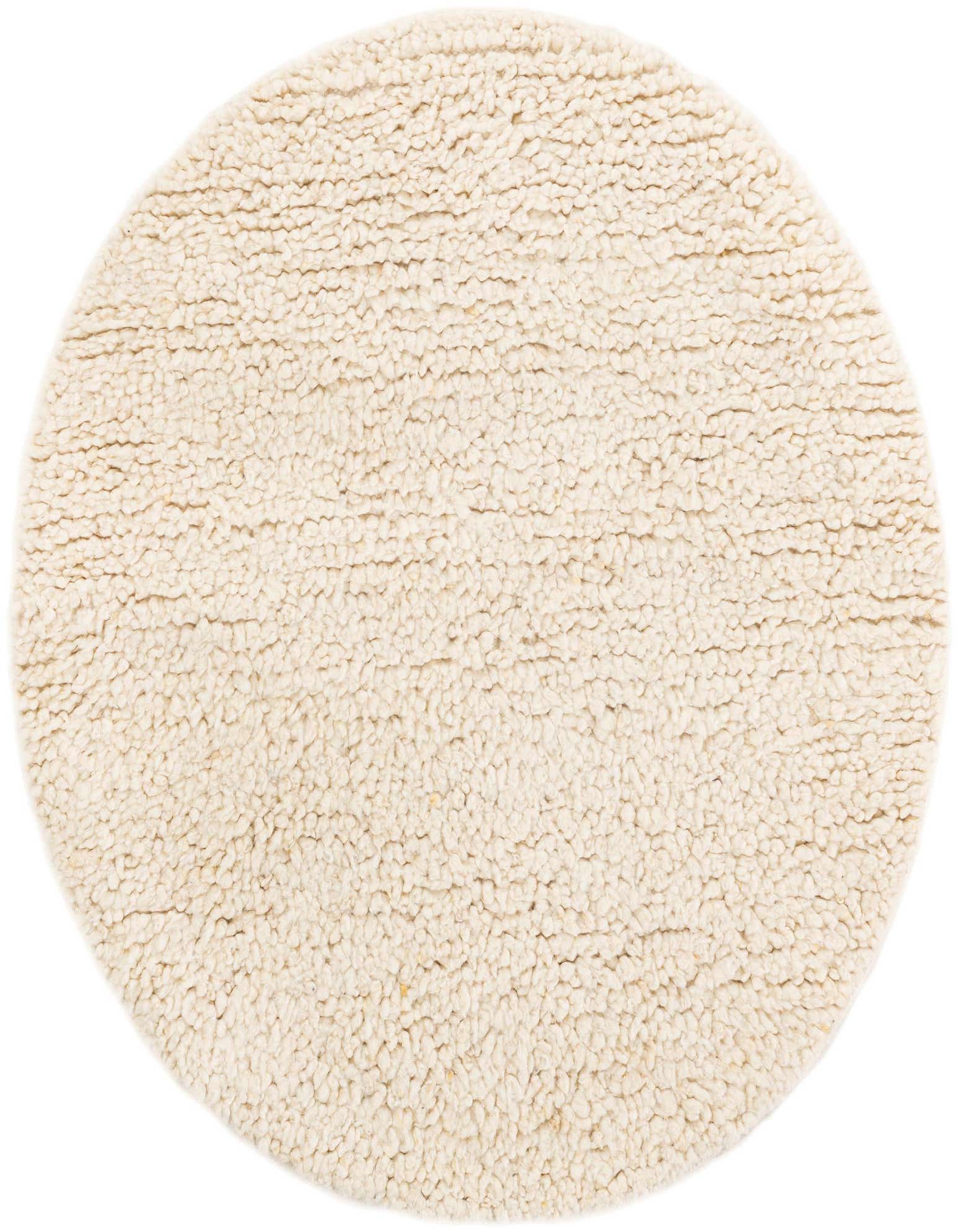 A round, cream-colored shag rug made of New Zealand wool, featuring a plush, textured pile, suitable for indoor spaces.