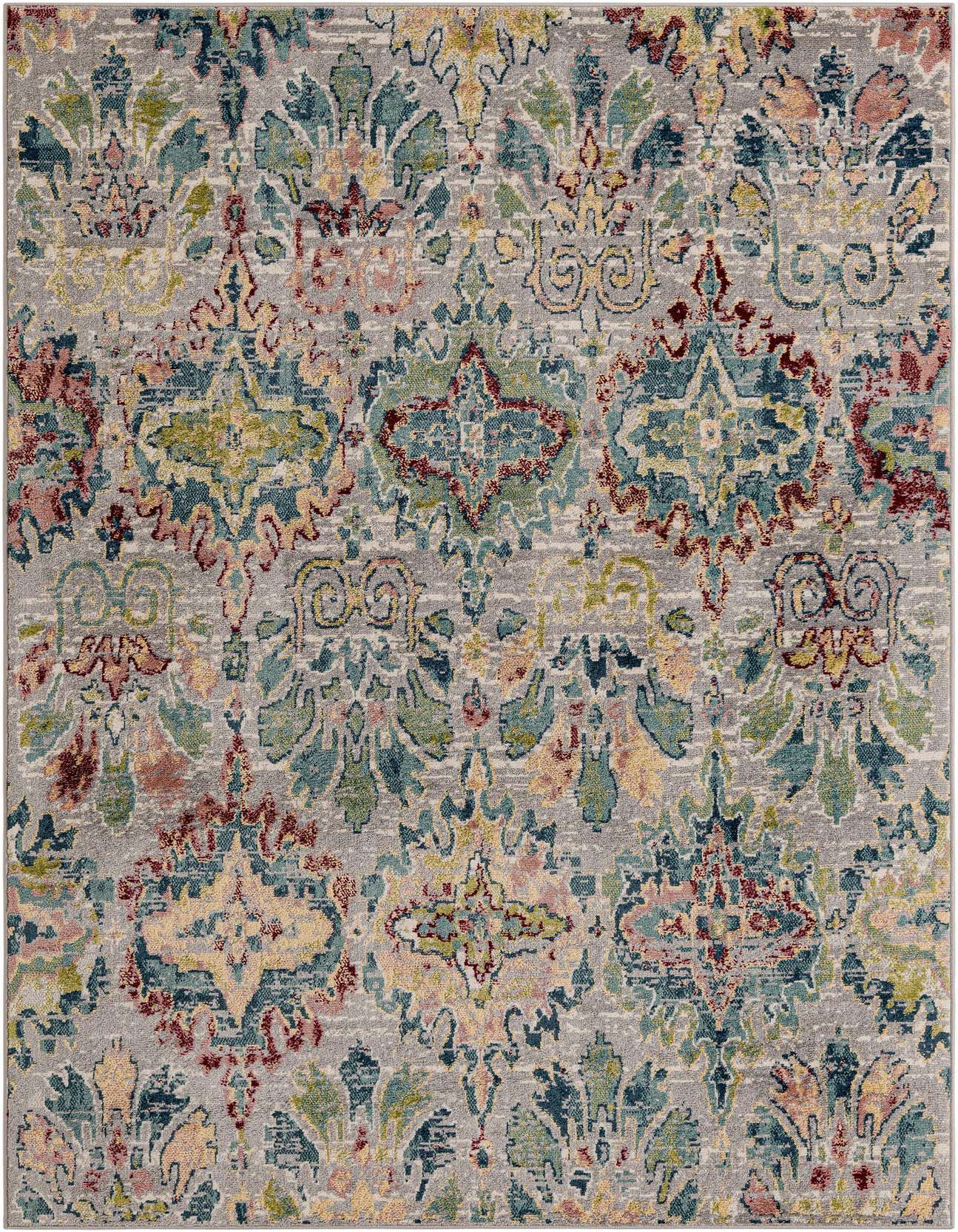A 6x9 rectangular multi-colored rug with an ornate, distressed floral pattern in shades of teal, red, yellow, and green on a grey background.