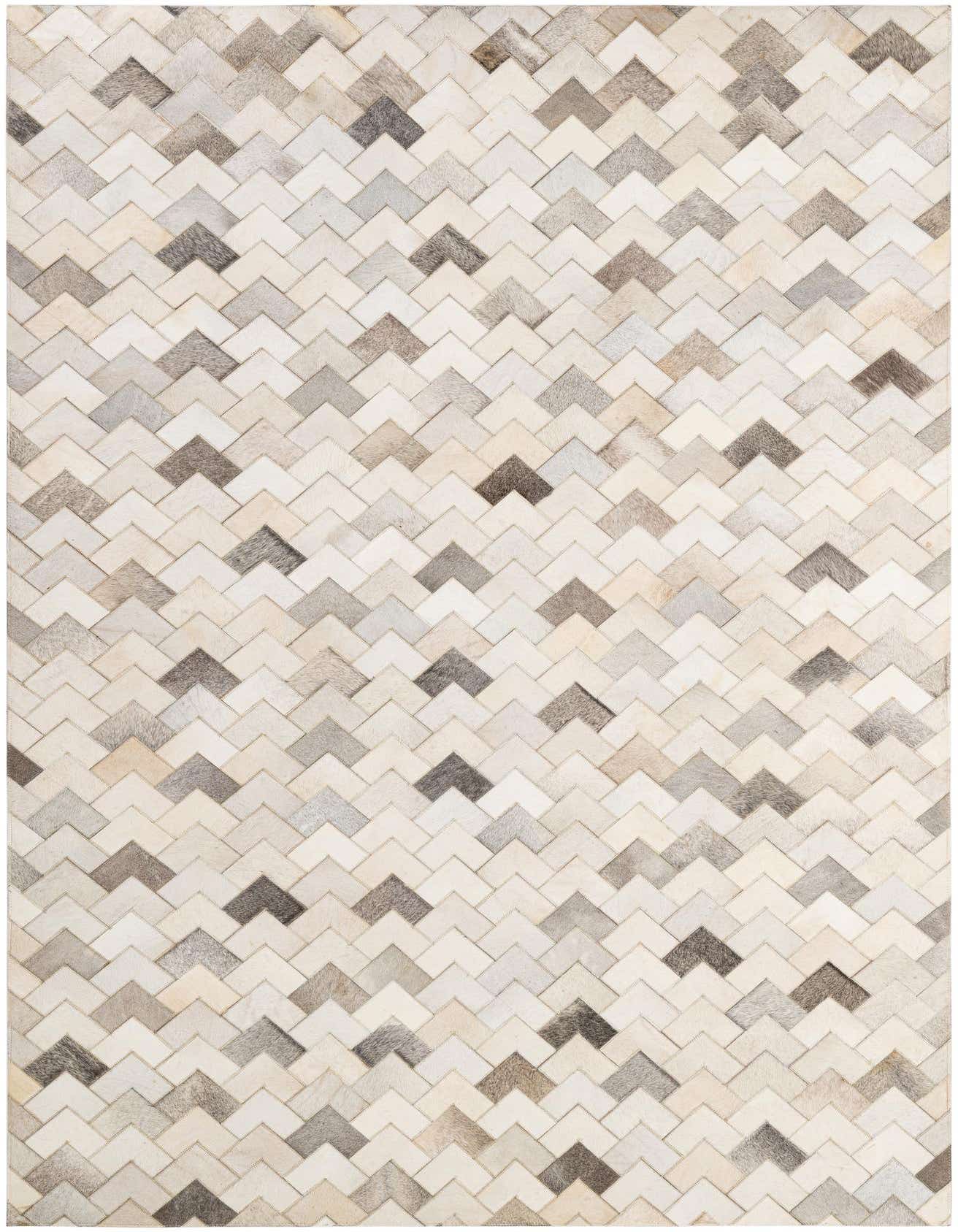 A 5x8 rectangular Cowhide Patchwork rug featuring a modern chevron pattern in shades of multi-colored natural cowhide and leather.