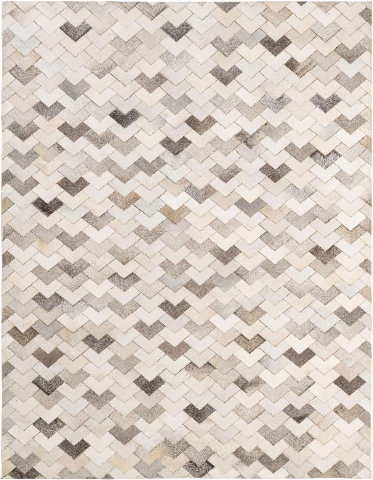 A 5x8 rectangular Cowhide Patchwork rug featuring a modern chevron pattern in various shades of multi-colored natural cowhide and leather.