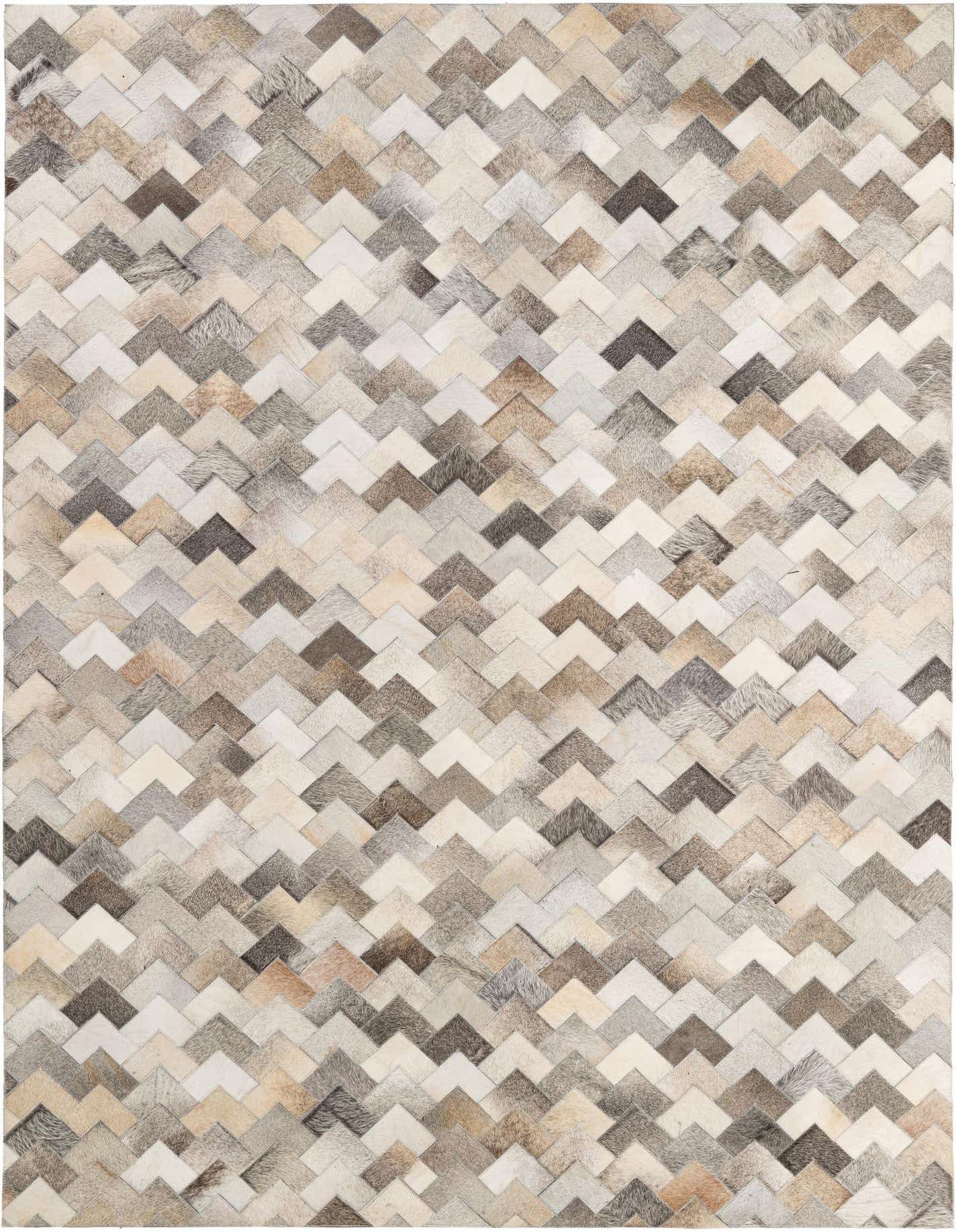 A 5x7 rectangular modern cowhide rug featuring a multi-colored chevron pattern in various shades of brown, grey, and cream.