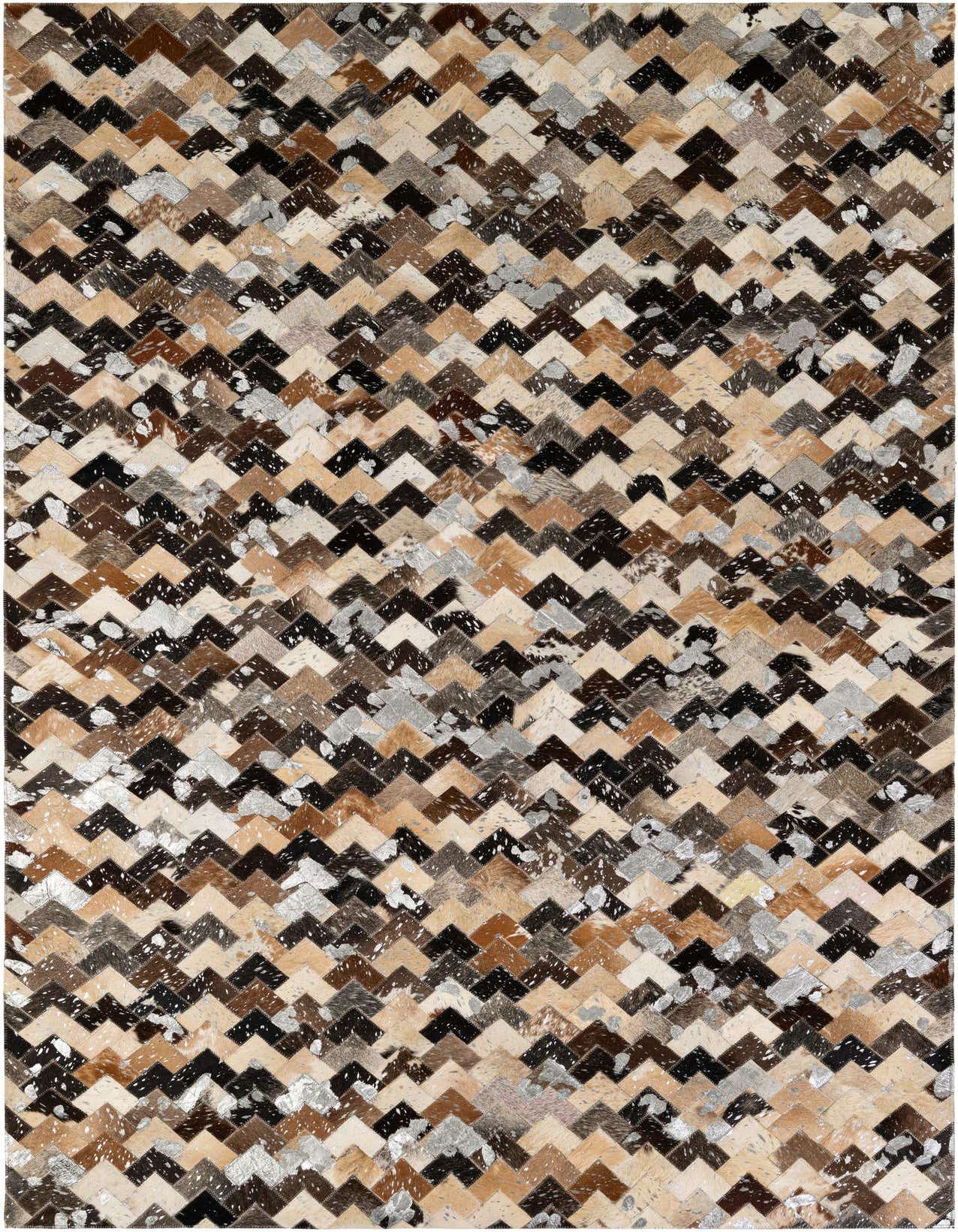 A rectangular 5x8 modern patchwork cowhide rug featuring a chevron pattern in various shades of brown, black, beige, and metallic silver.