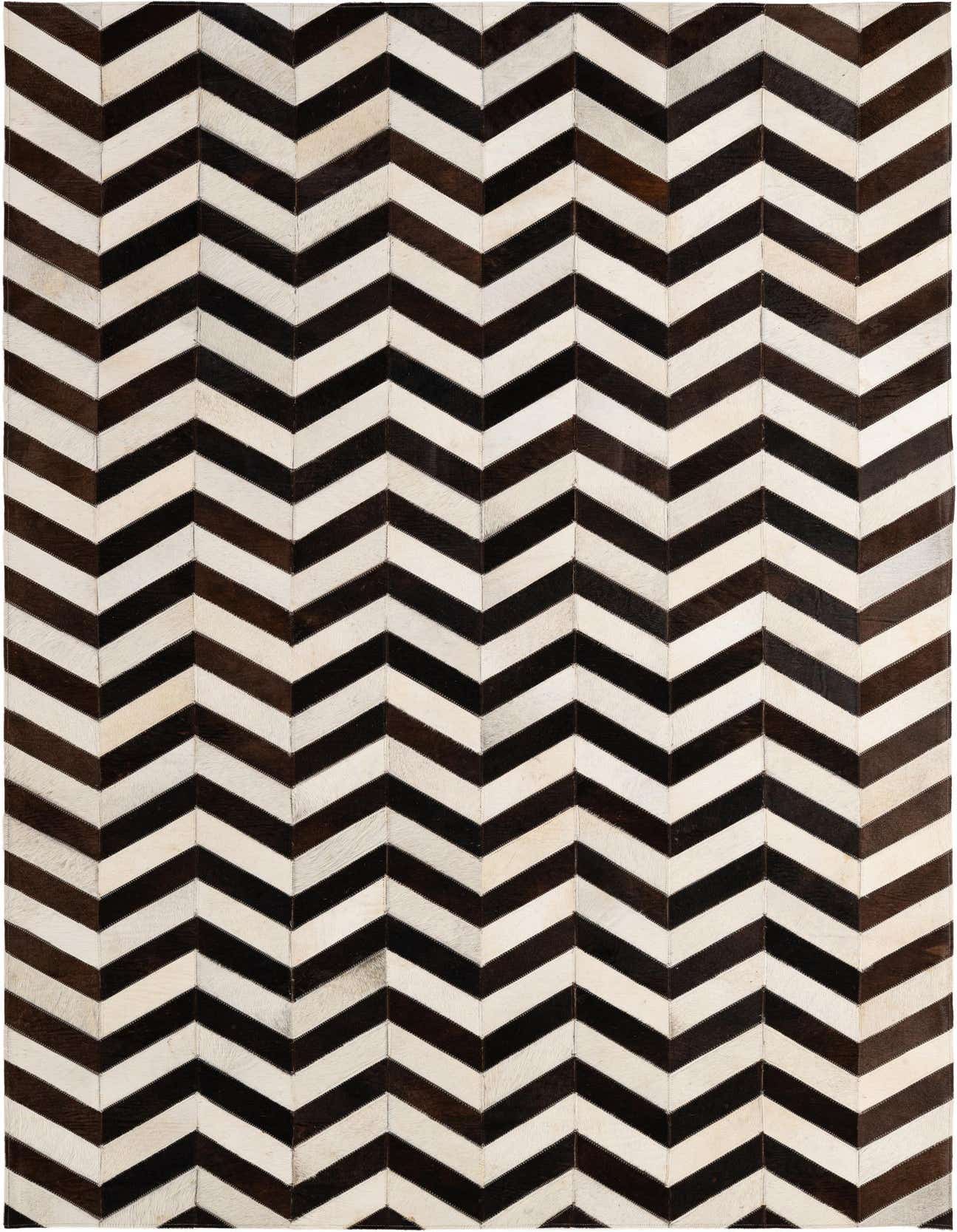 A 5x8 rectangular cowhide rug featuring a bold, modern chevron pattern in alternating stripes of dark brown and off-white, ideal for a living room.
