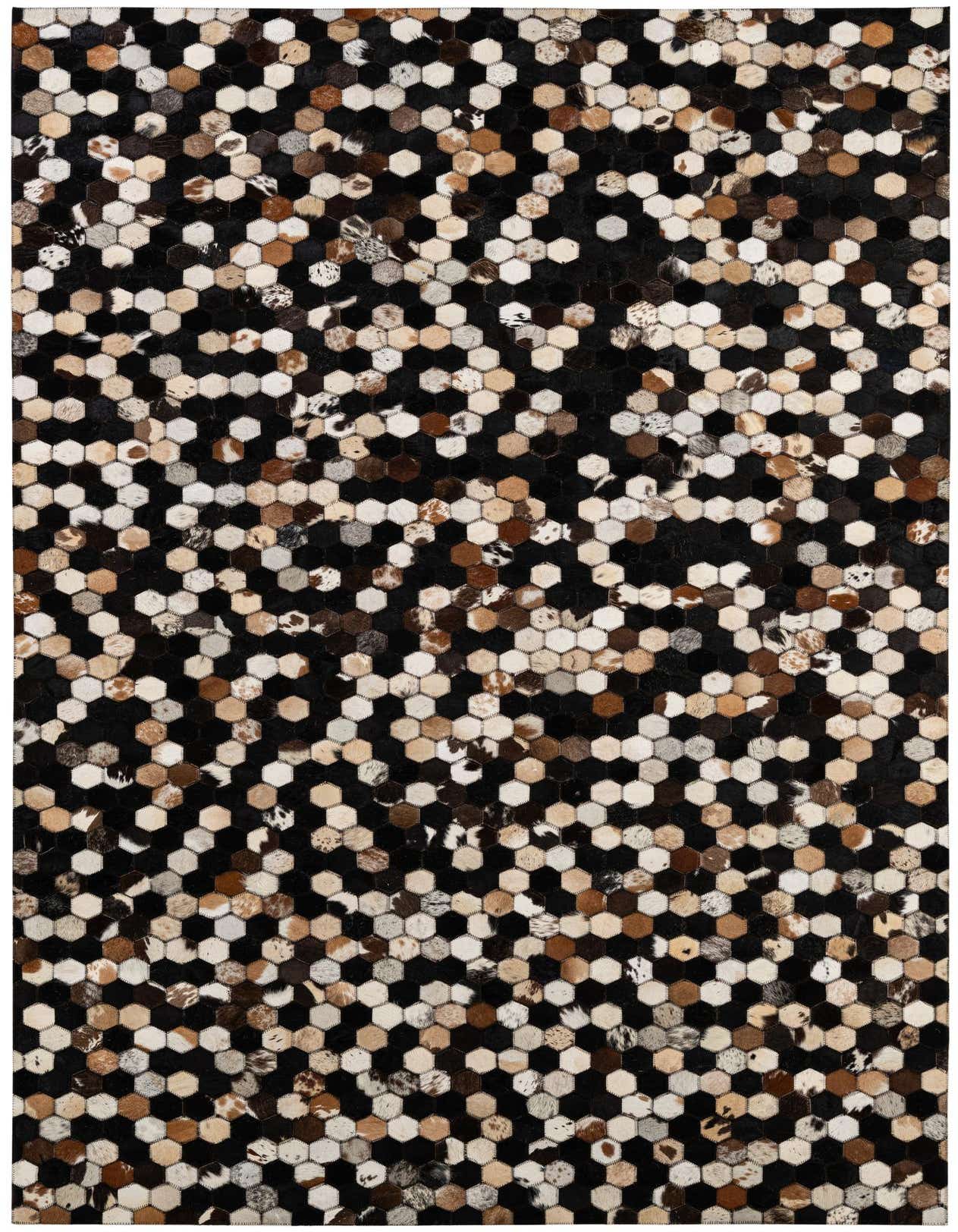 A rectangular 5x8 modern patchwork cowhide rug with multi-colored hexagonal pieces in black, white, brown, and tan.