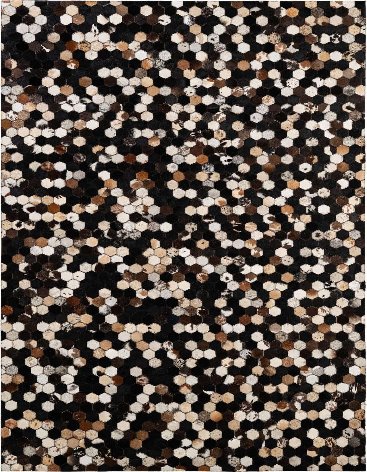 A rectangular 5x8 modern patchwork cowhide rug featuring a mosaic of hexagonal pieces in black, white, brown, and tan.