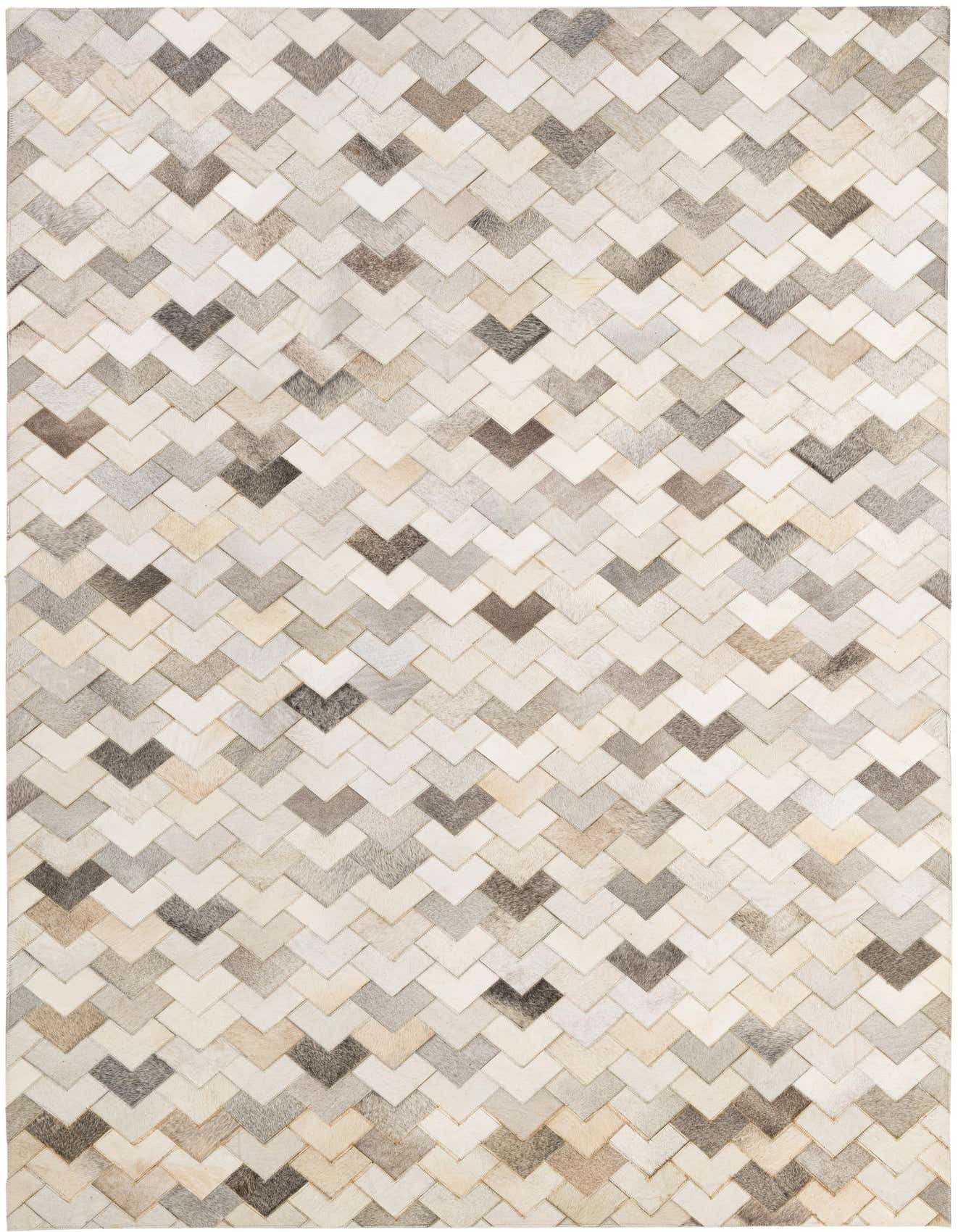 A rectangular 5x8 modern cowhide patchwork rug featuring a chevron pattern in various shades of multi-colored natural cowhide.