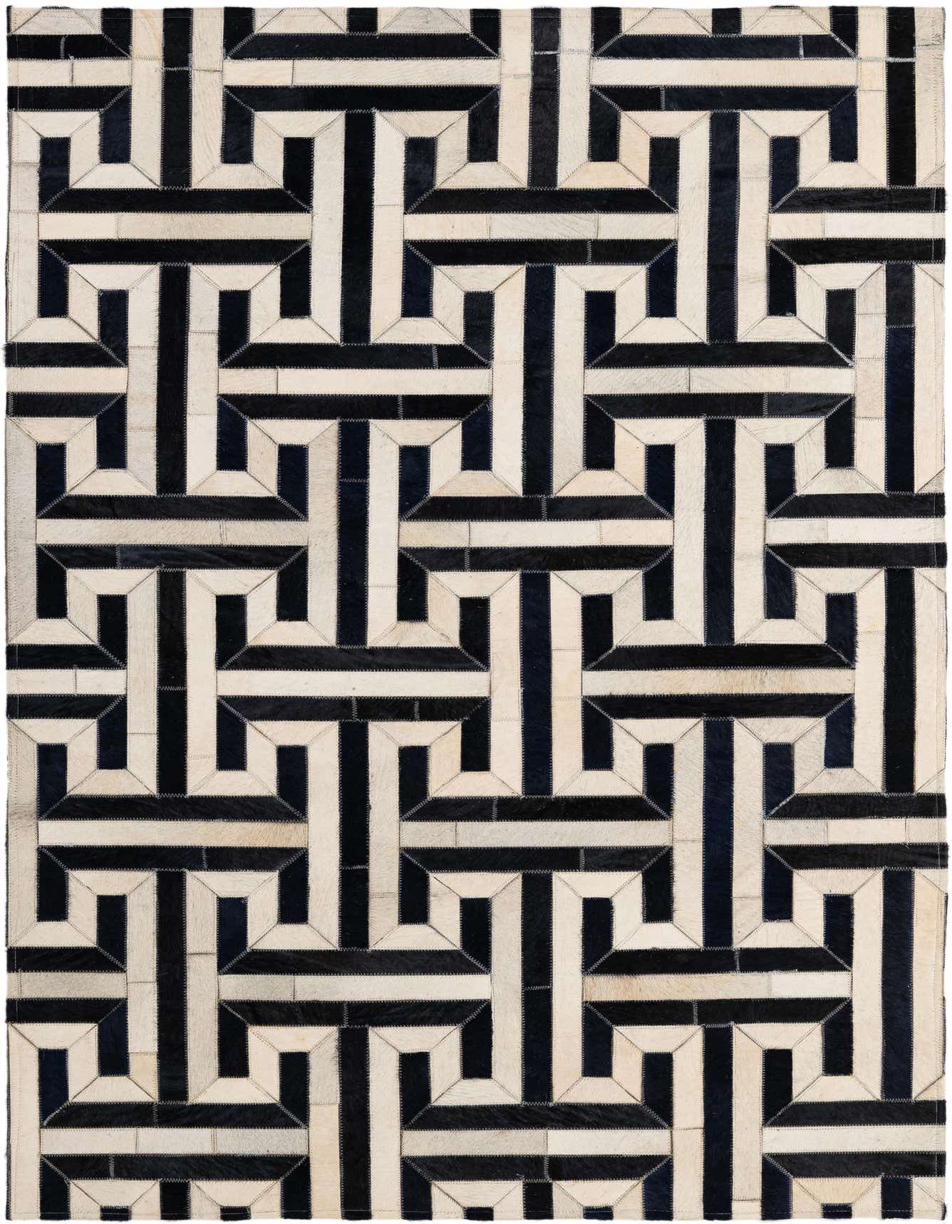 A 4x6 rectangular cowhide rug with a bold black and white modern geometric pattern, handmade from leather.