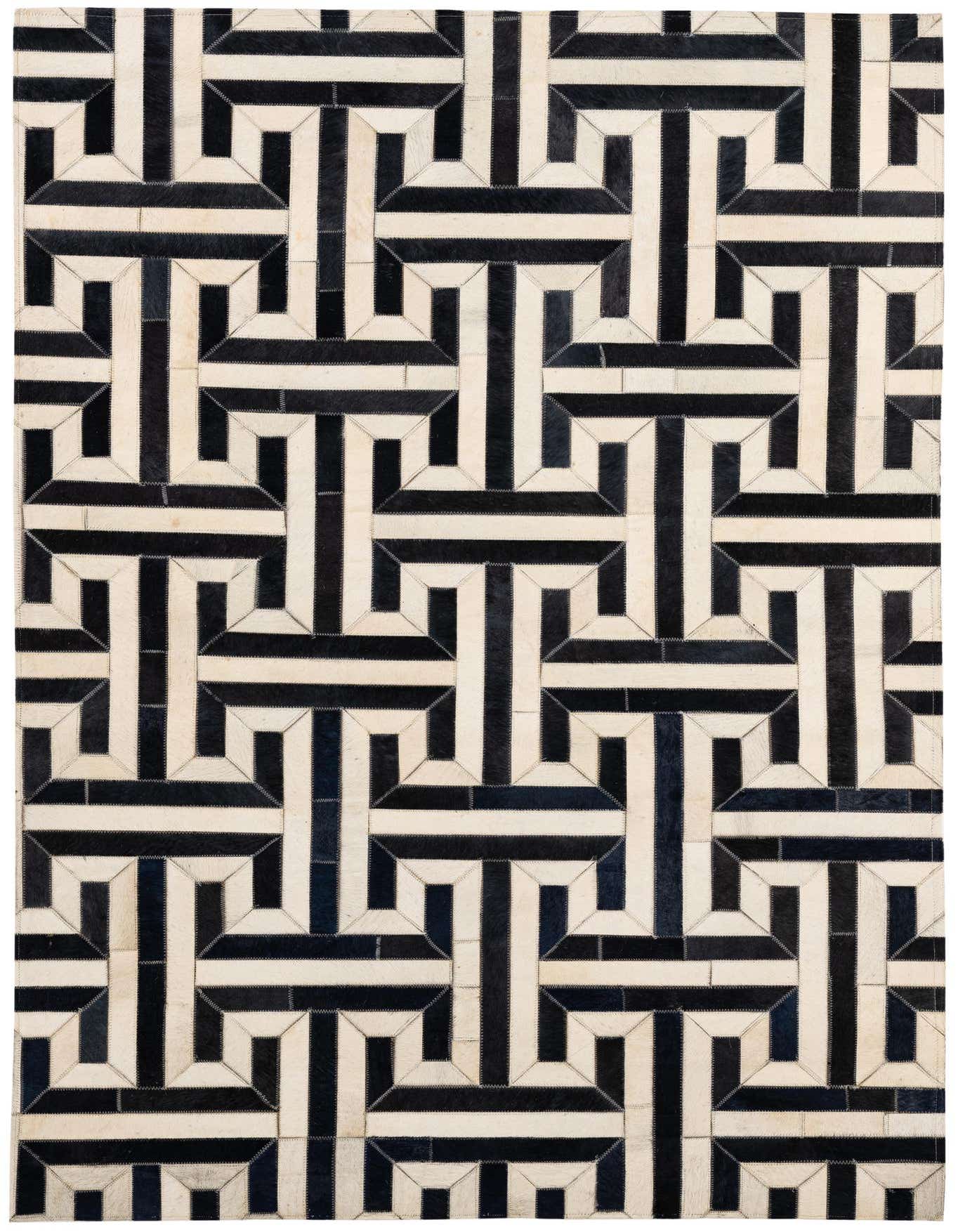 A 4x6 rectangular Cowhide - Patchwork rug with a modern geometric pattern in black and white, suitable for a living room.