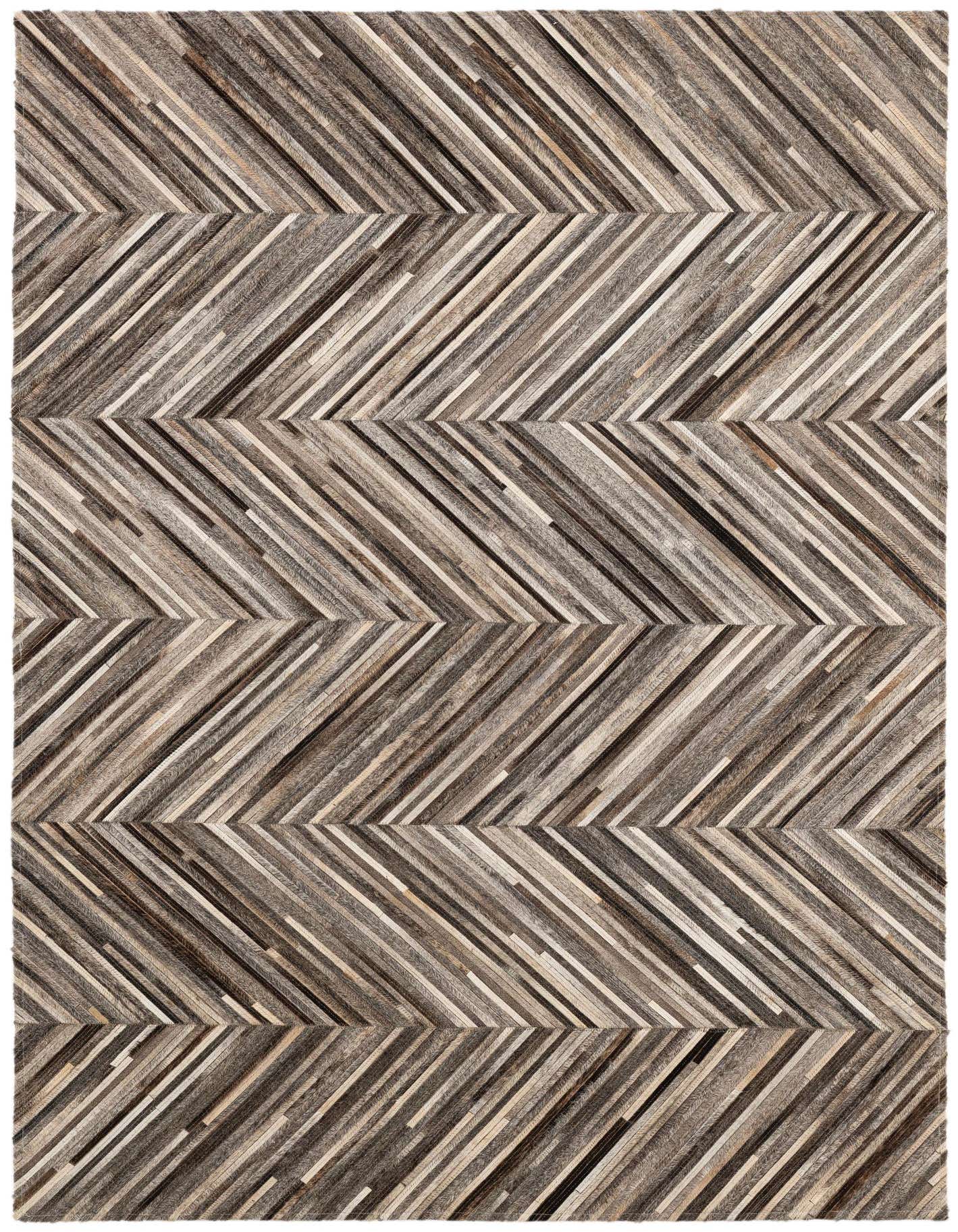 A 4x6 rectangular Cowhide Patchwork rug featuring a modern chevron pattern in various shades of brown, grey, and cream.
