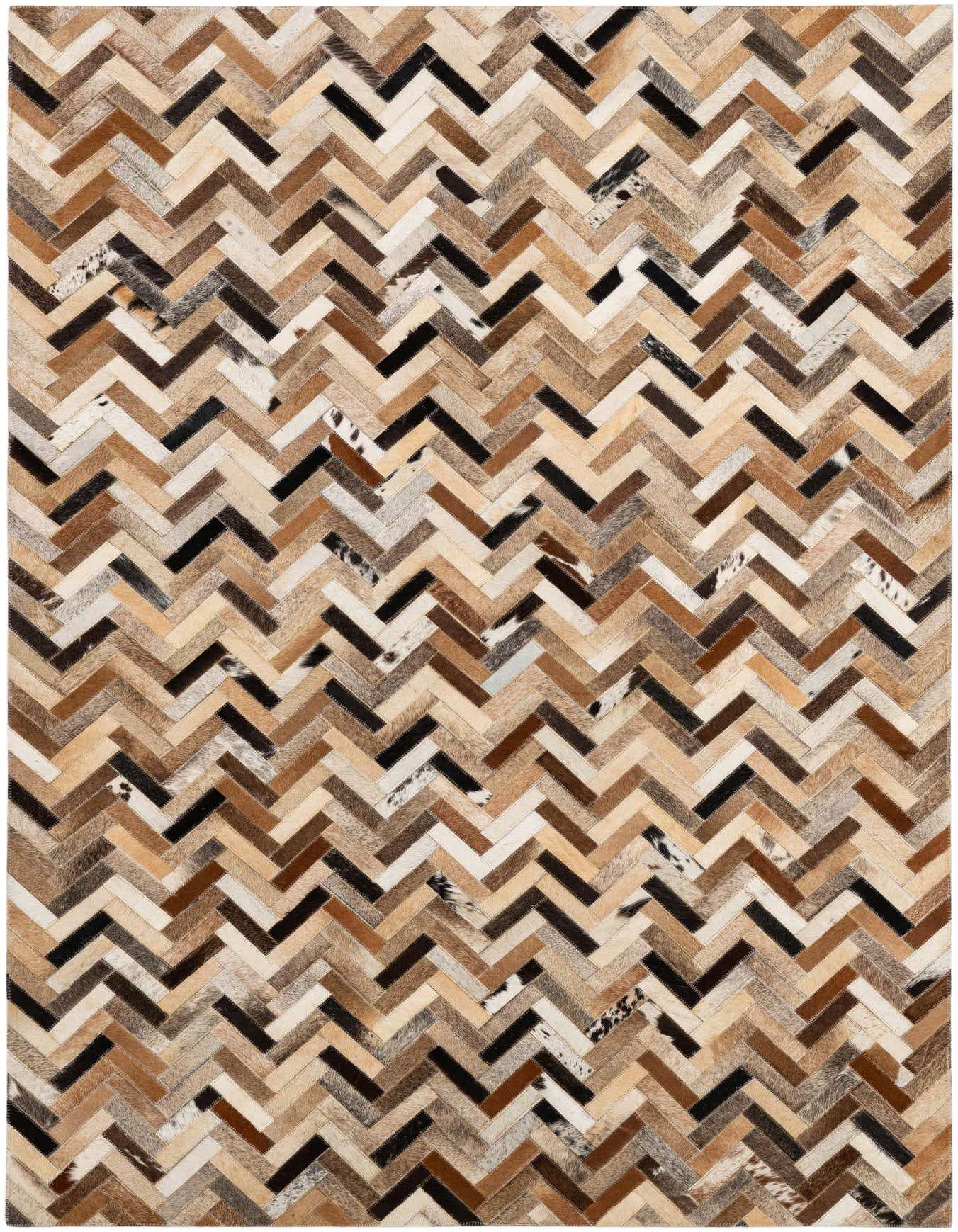 A 4x6 rectangular multi-colored cowhide rug with a modern chevron patchwork pattern, perfect for a living room.