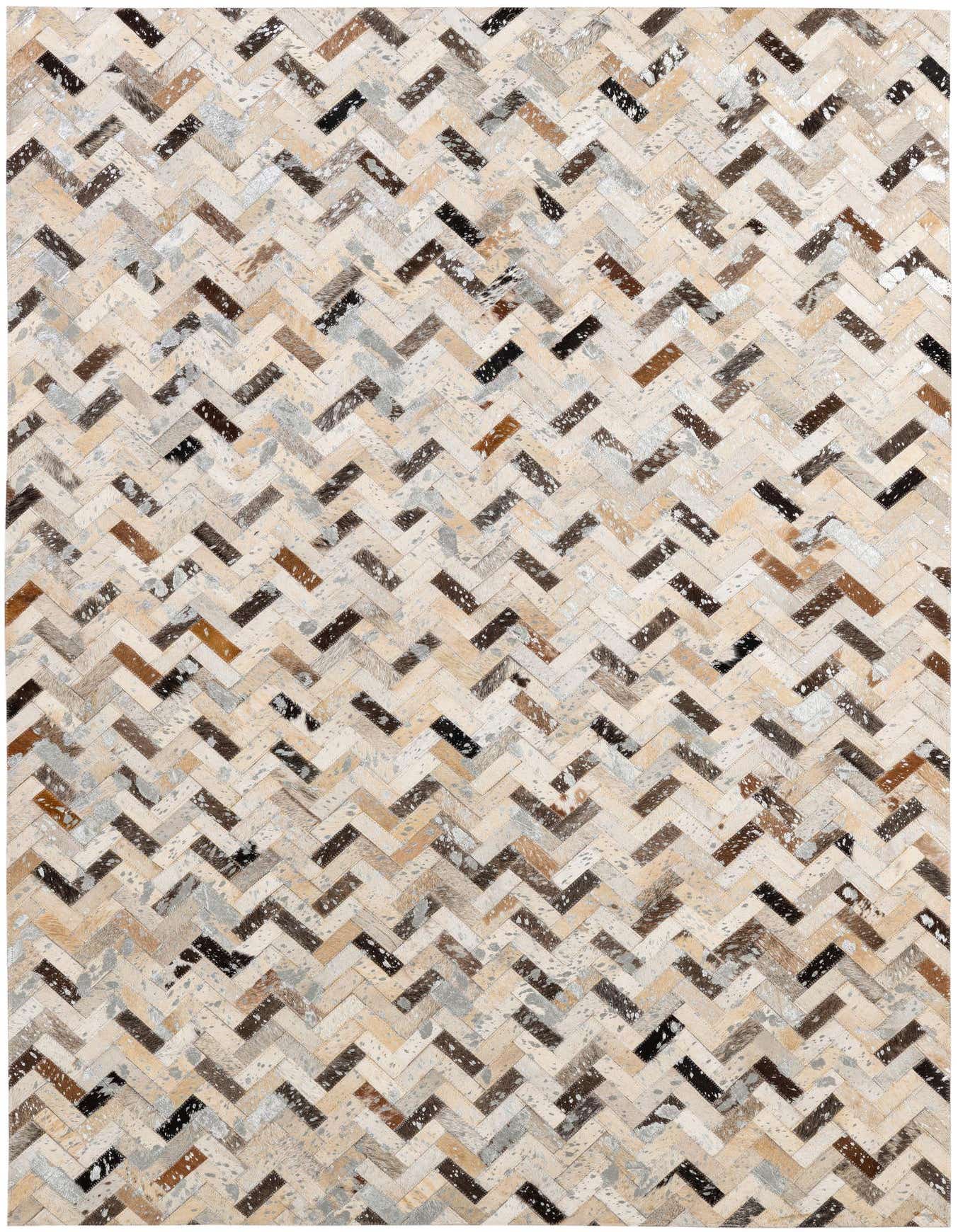 A 4x6 rectangular cowhide rug with a modern multi-colored chevron patchwork pattern in natural browns, creams, grays, and black.