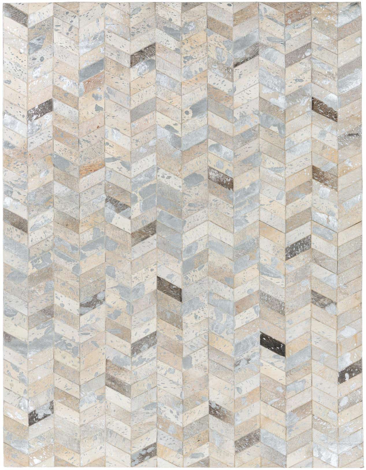 A rectangular 5x8 modern cowhide and leather rug with a multi-colored chevron stripe pattern, featuring shades of cream, beige, grey, and brown.