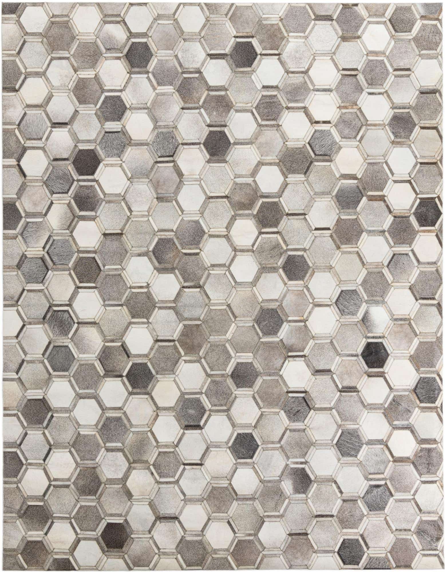 A rectangular 8x10 Cowhide Leather rug featuring a modern geometric pattern of multi-colored hexagonal patches in varying shades of gray, white, and brown.