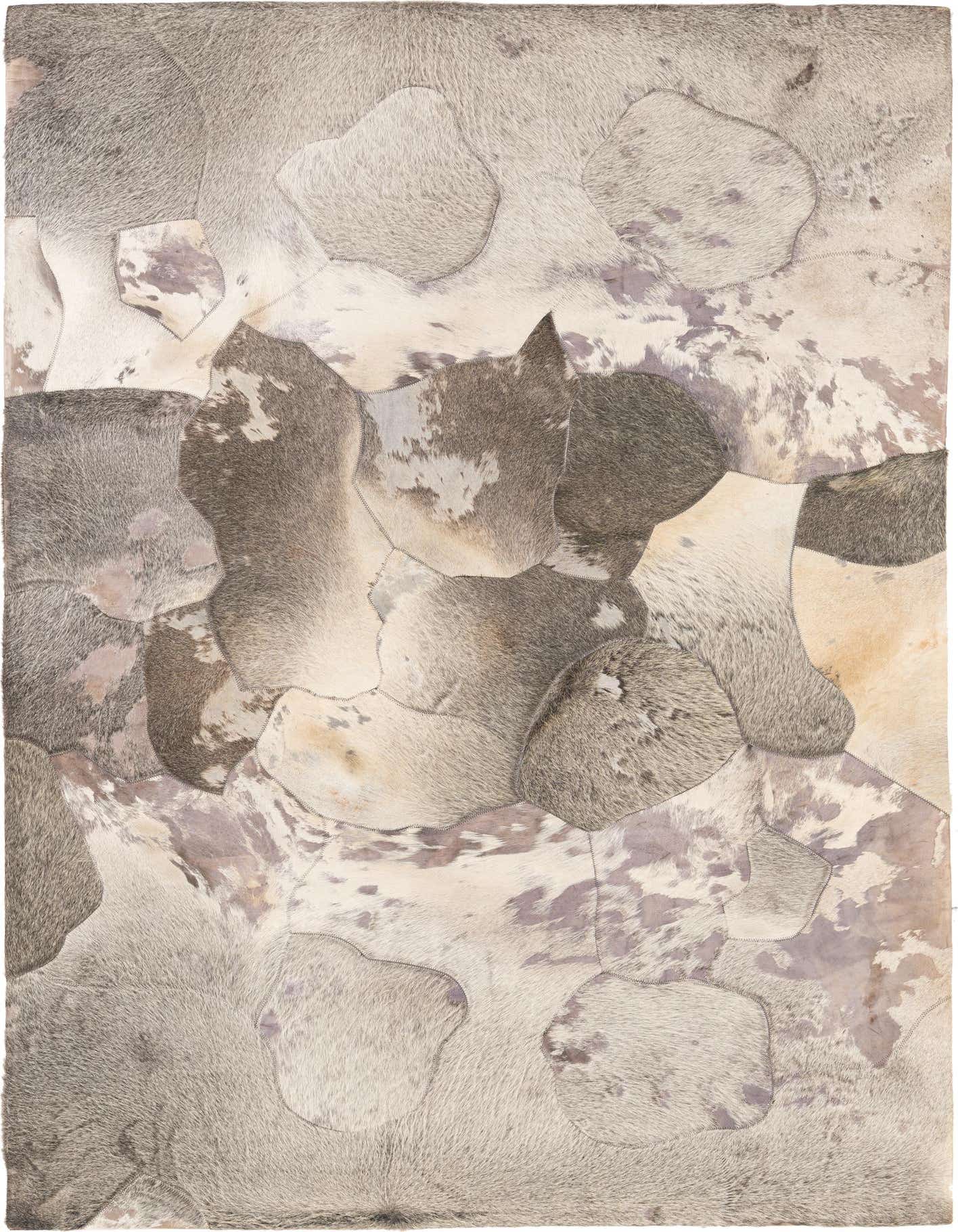 A rectangular 5x8 multi-colored cowhide rug with an abstract patchwork pattern, ideal for a modern living room.