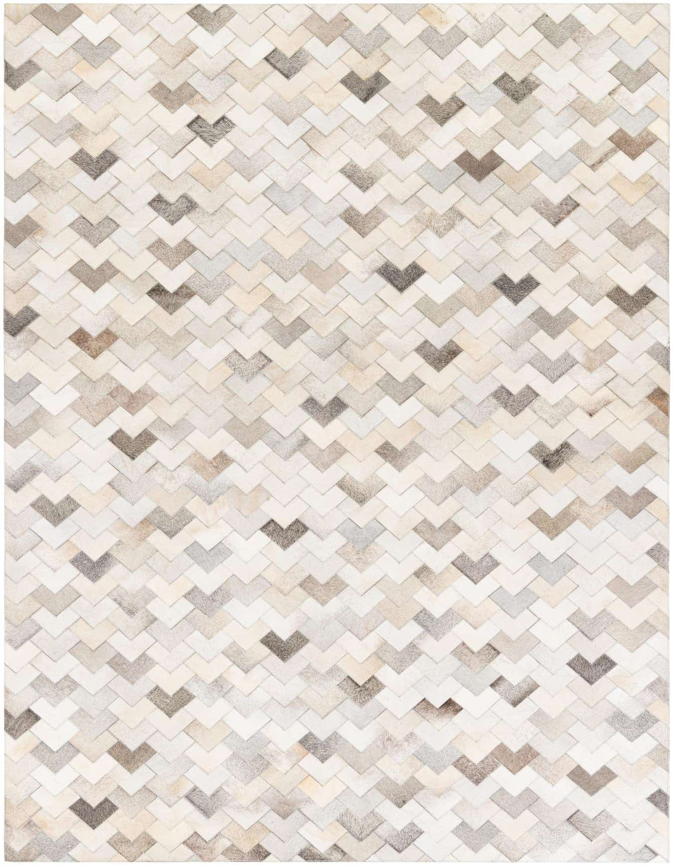 A 6x9 rectangular modern rug made of multi-colored cowhide and leather in a chevron pattern, ideal for a living room.