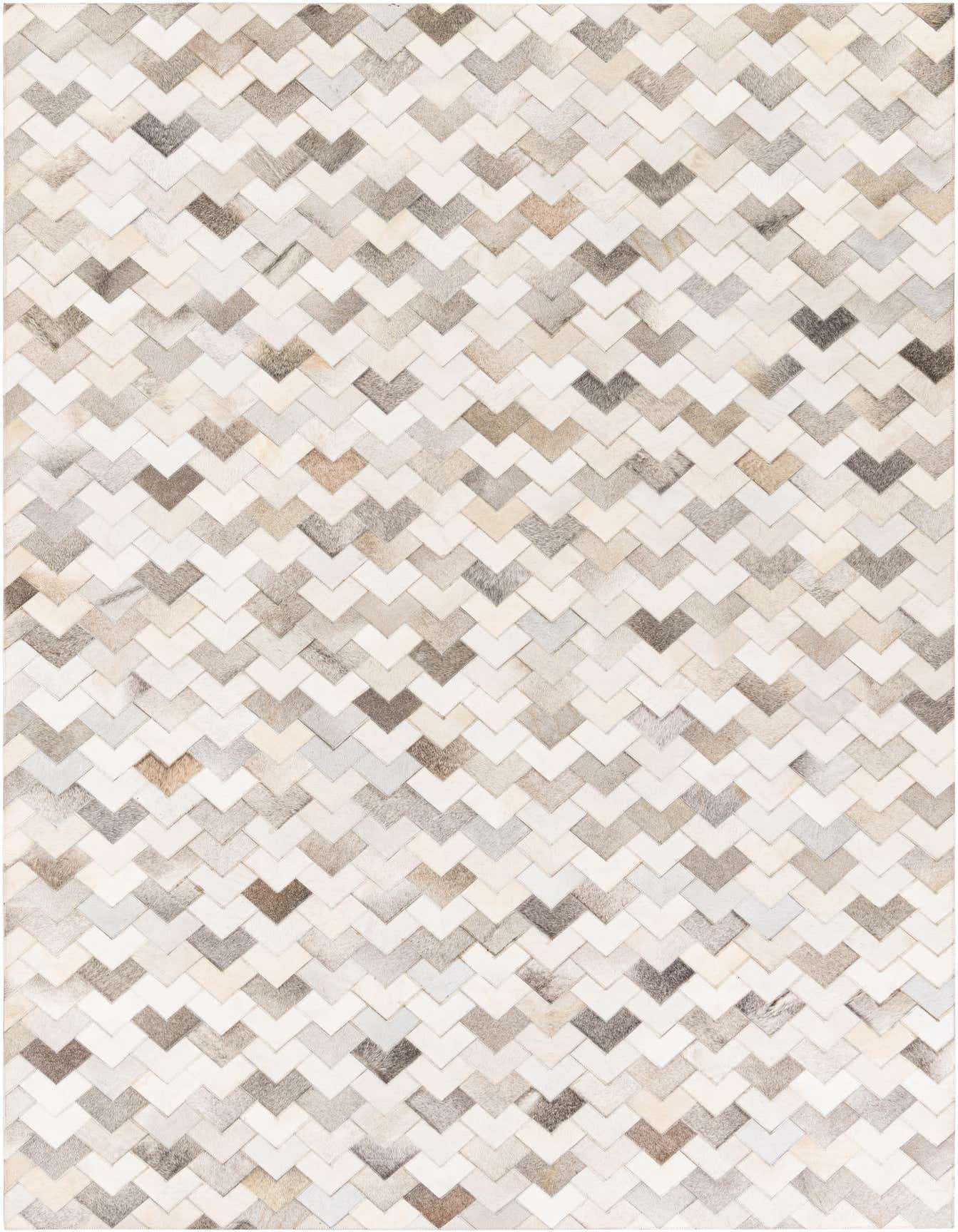 A 6x9 rectangular modern cowhide rug featuring a chevron pattern in various shades of brown, beige, and white.