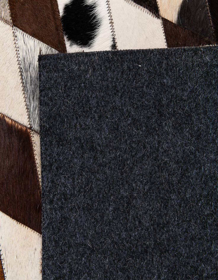 Detail image of  6' 7 x 9' 10 Cowhide Stocks Rug