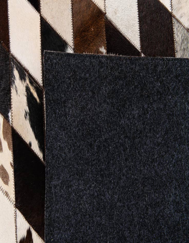 Detail image of  6' 7 x 9' 10 Cowhide Stocks Rug