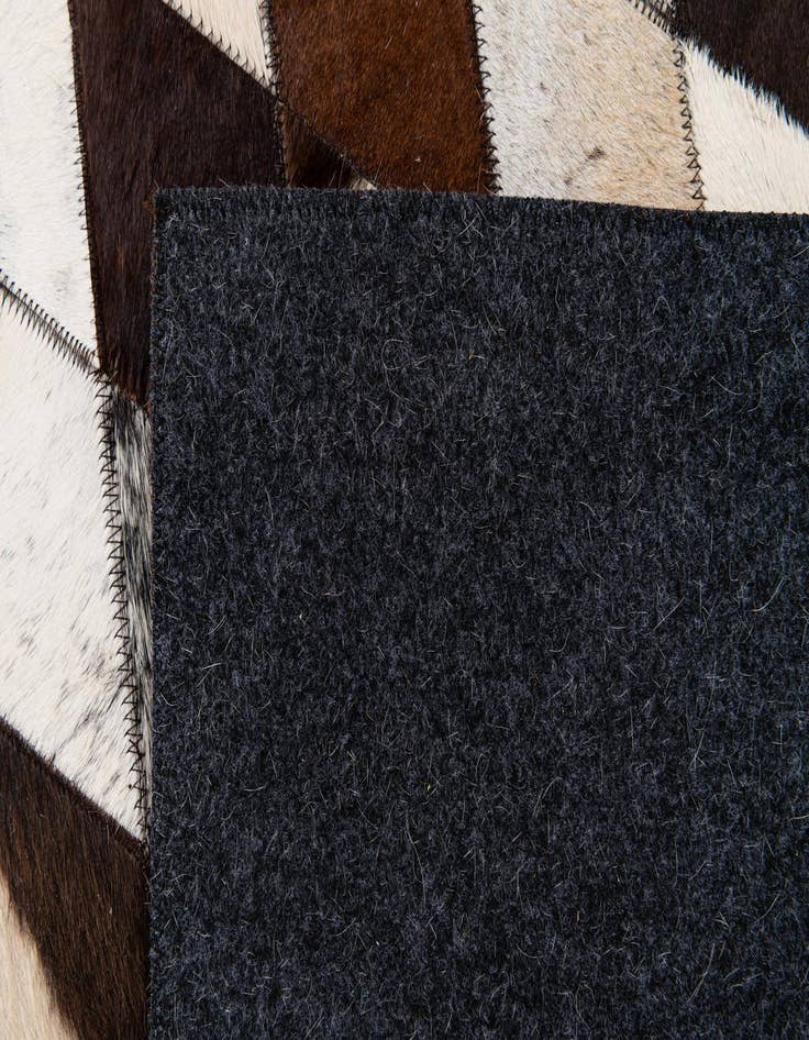 Detail image of  6' 7 x 9' 11 Cowhide Stocks Rug